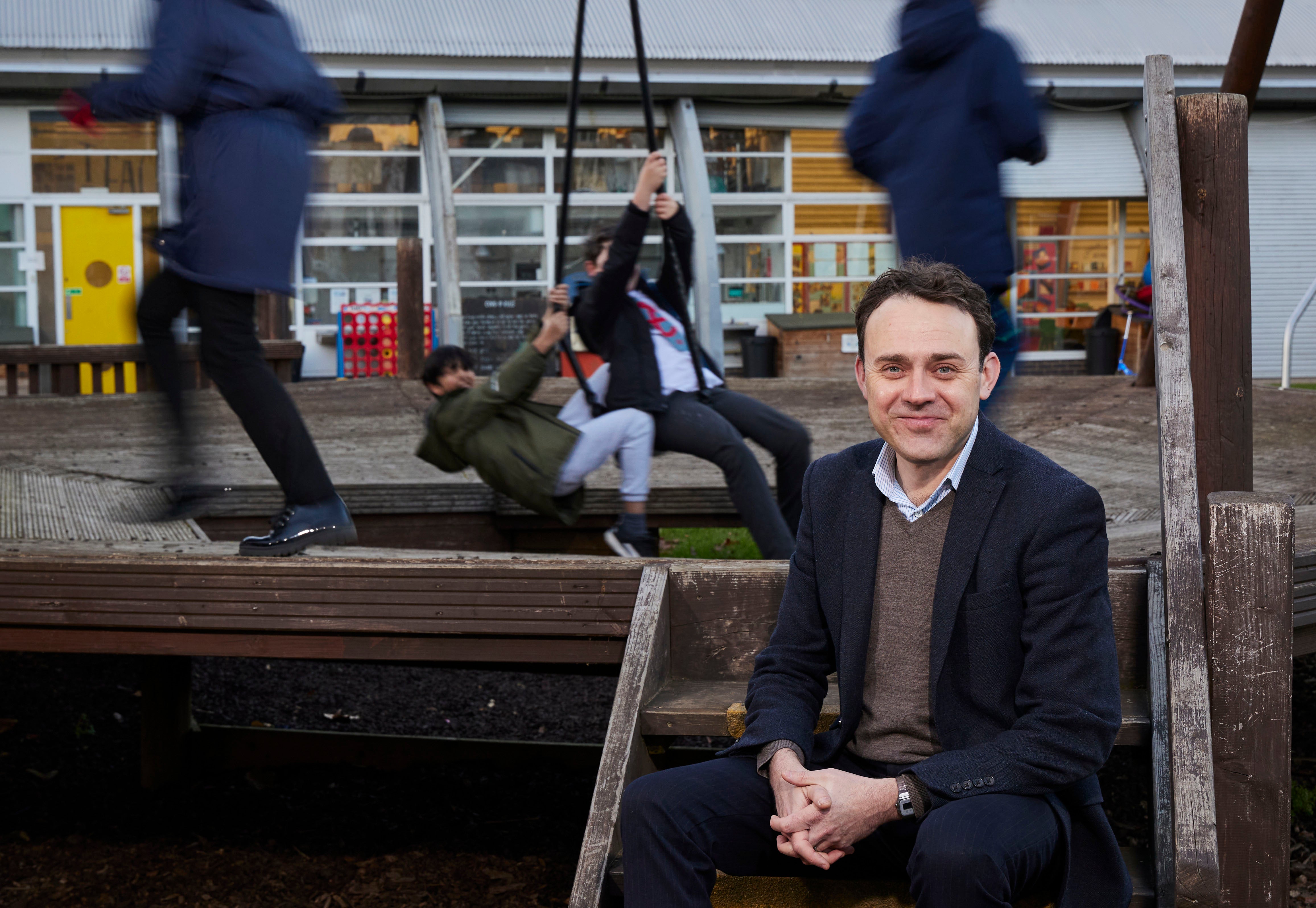 CEO of Ambition Aspire Achieve Jonny Boux, with children from the group at Arc in the Park, Canning Town, east London