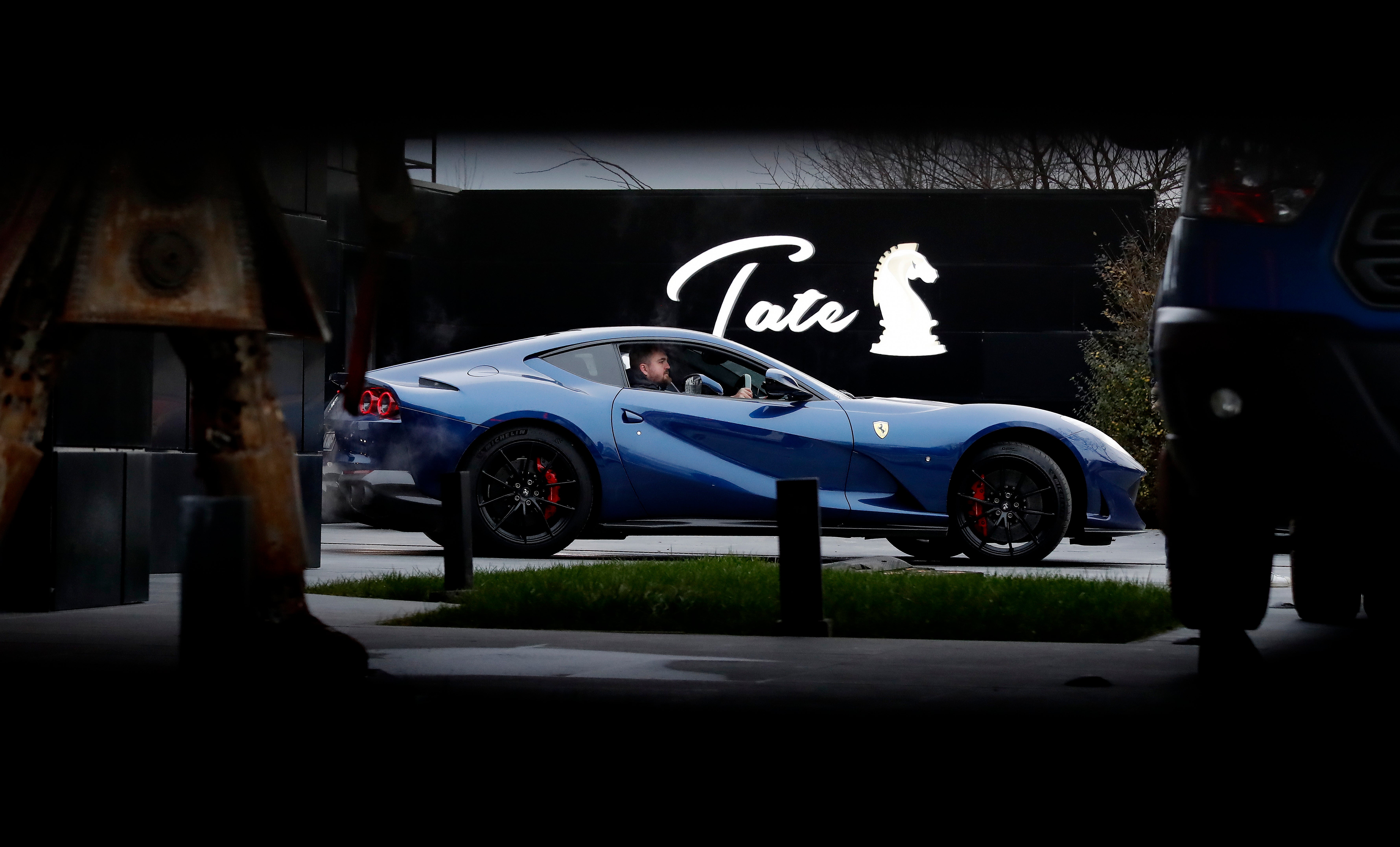 Tate’s Ferrari is prepared for towing by a Romanian police officer