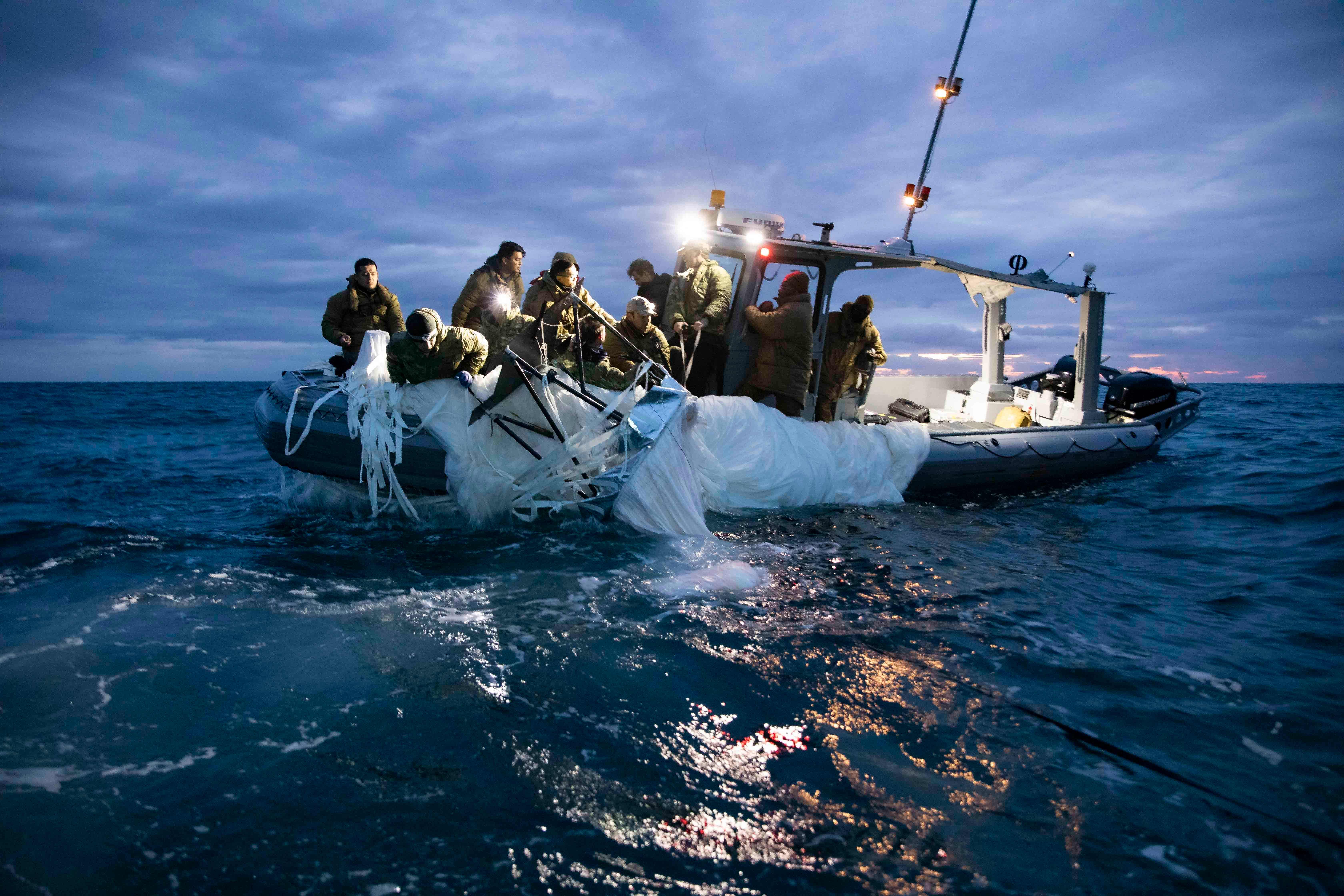 US Navy sailors recover a shot-down Chinese surveillance balloon from the Atlantic Ocean on 6 February.