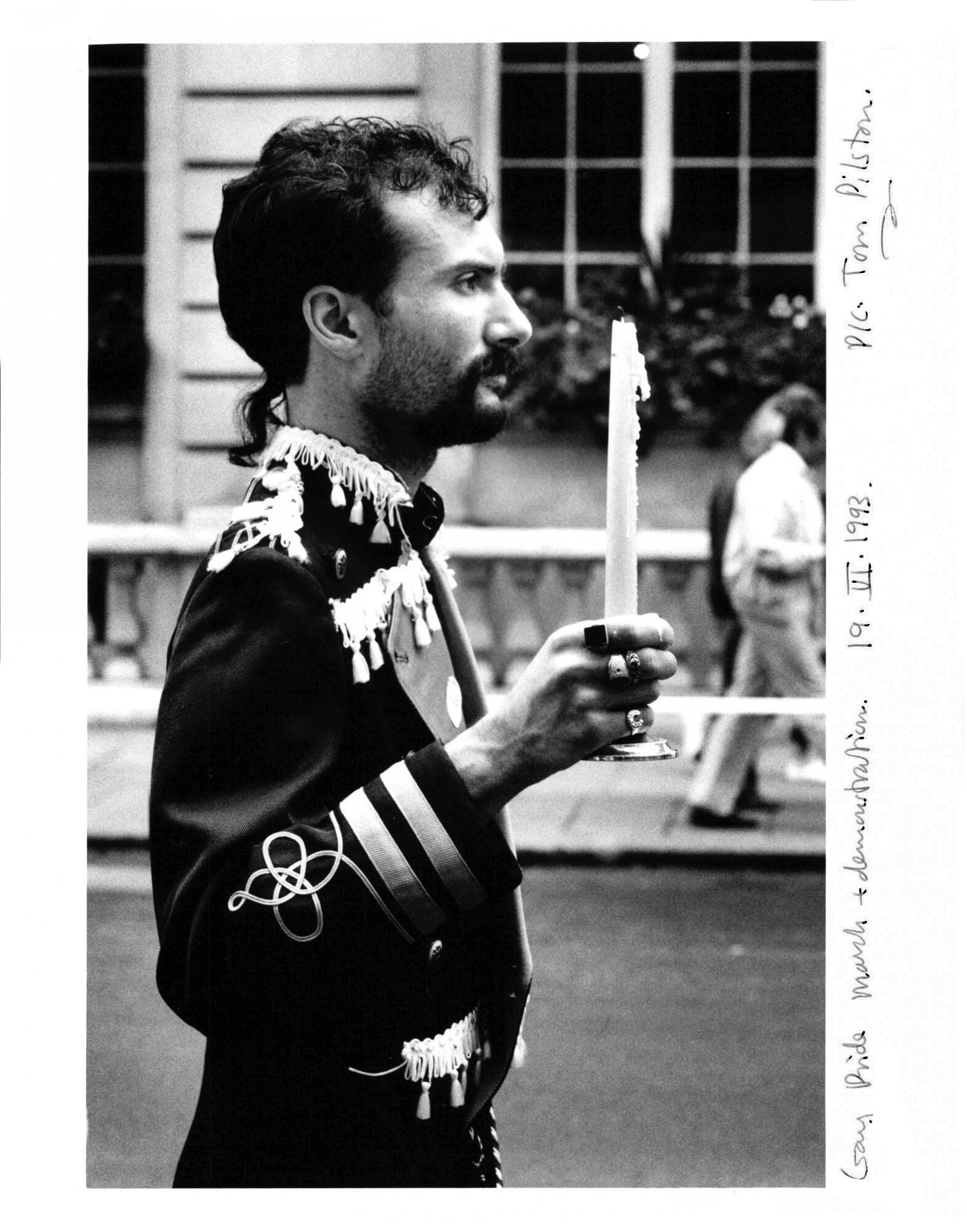 Man holding a candle on the Gay Pride march in London, 1993.