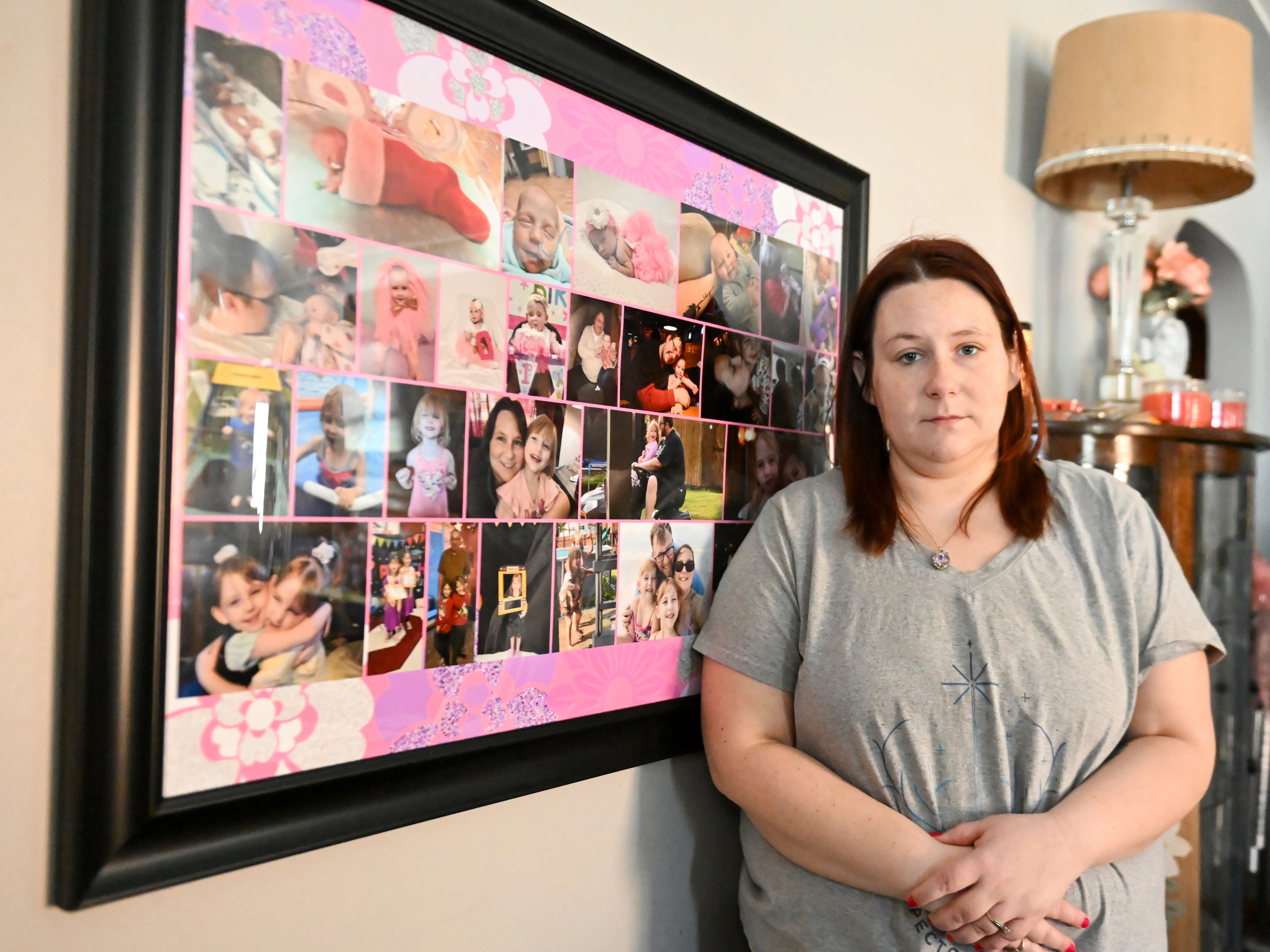 Jessica Day-Weaver poses next to a picture collage made for her daughter, Anastasia, at her home, Thursday, Feb. 2, 2022, in Boardman, Ohio