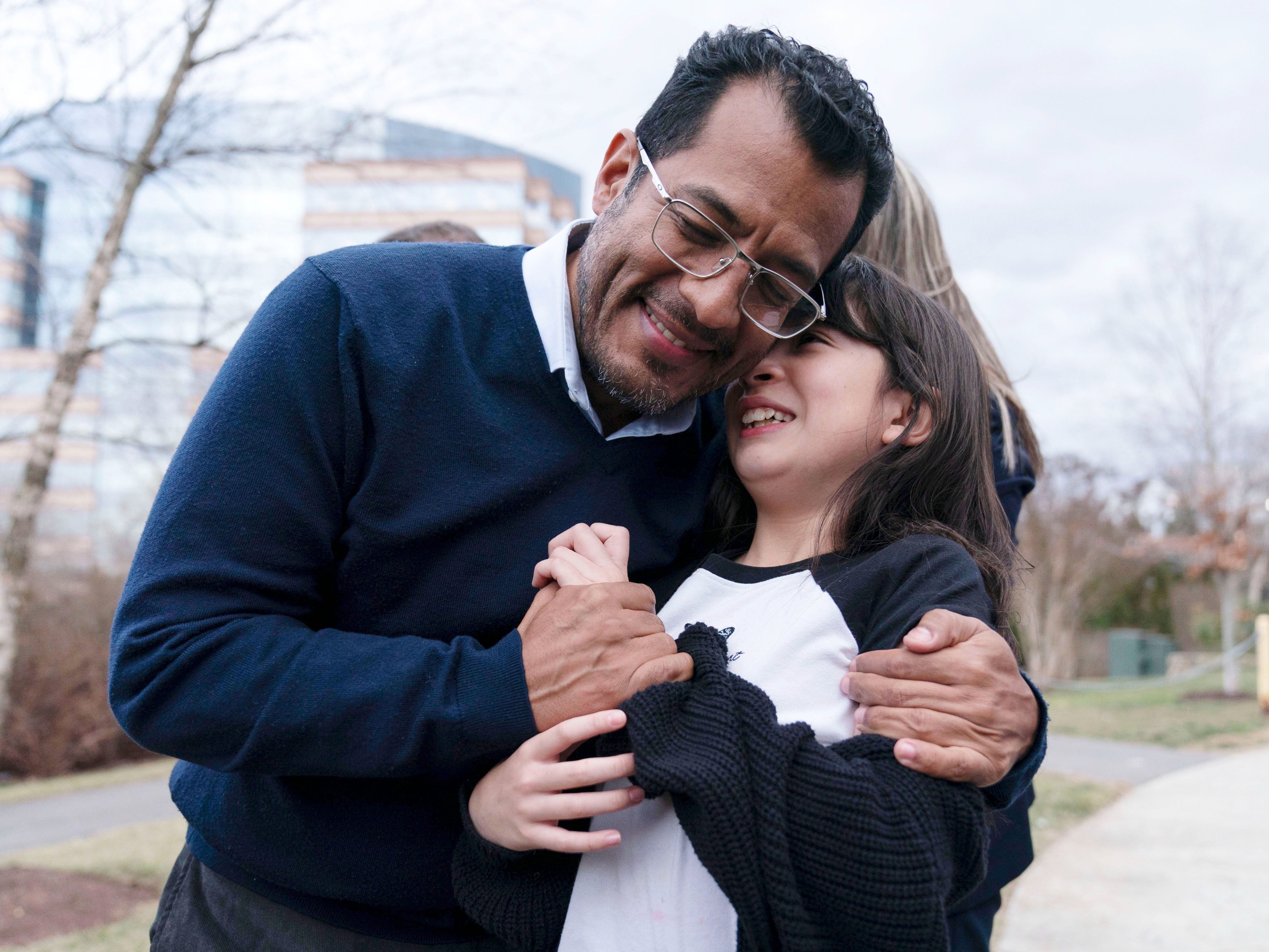 Former Nicaragua presidential candidate Felix Maradiaga hugs his daughter Alejandra after arriving at Dulles International Airport on Thursday 9 February 2023