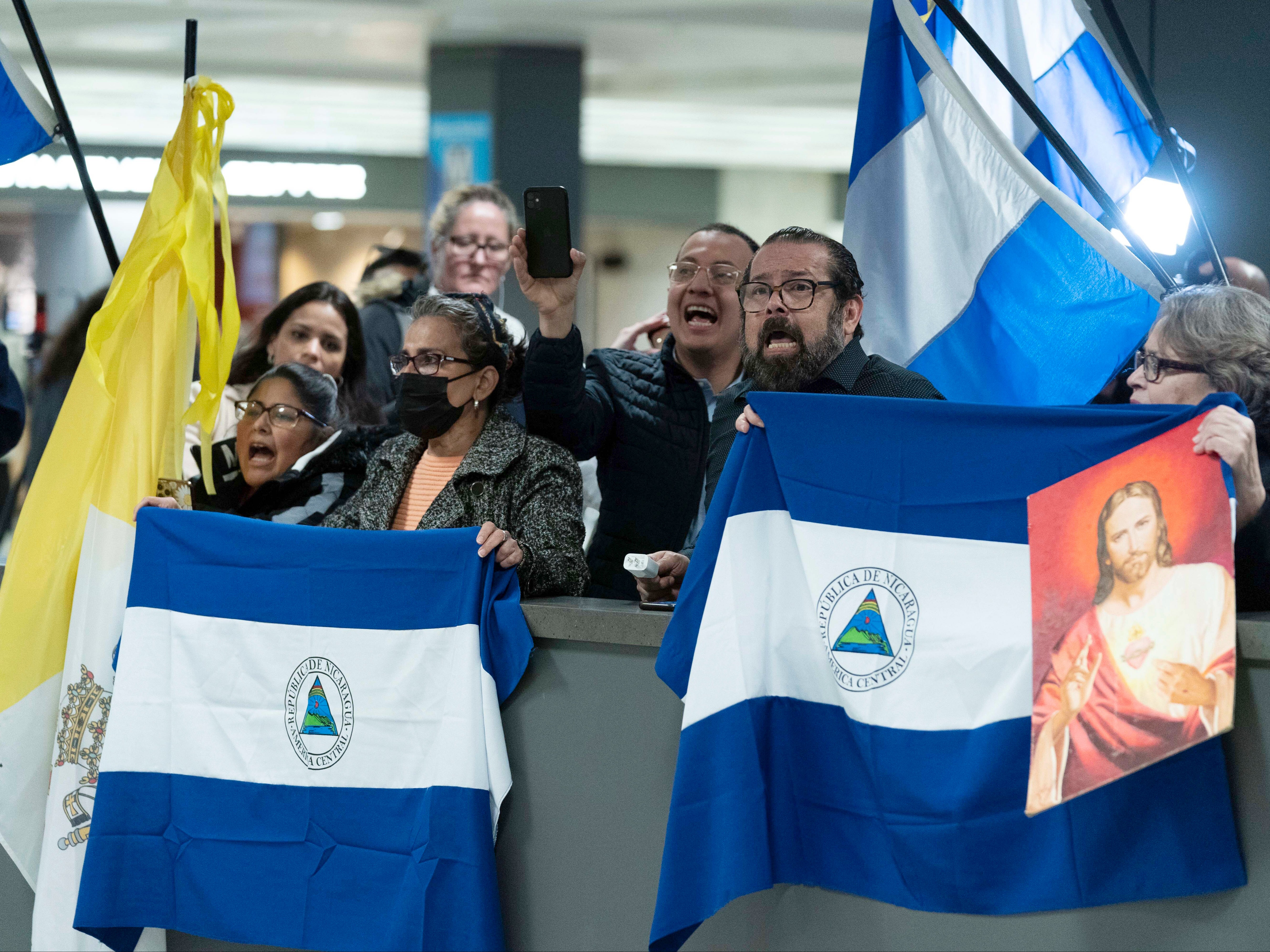 Supporters of Nicaraguan political prisoners chant at Washington Dulles International Airport ahead of their arrival on Thursday 9 February 2023