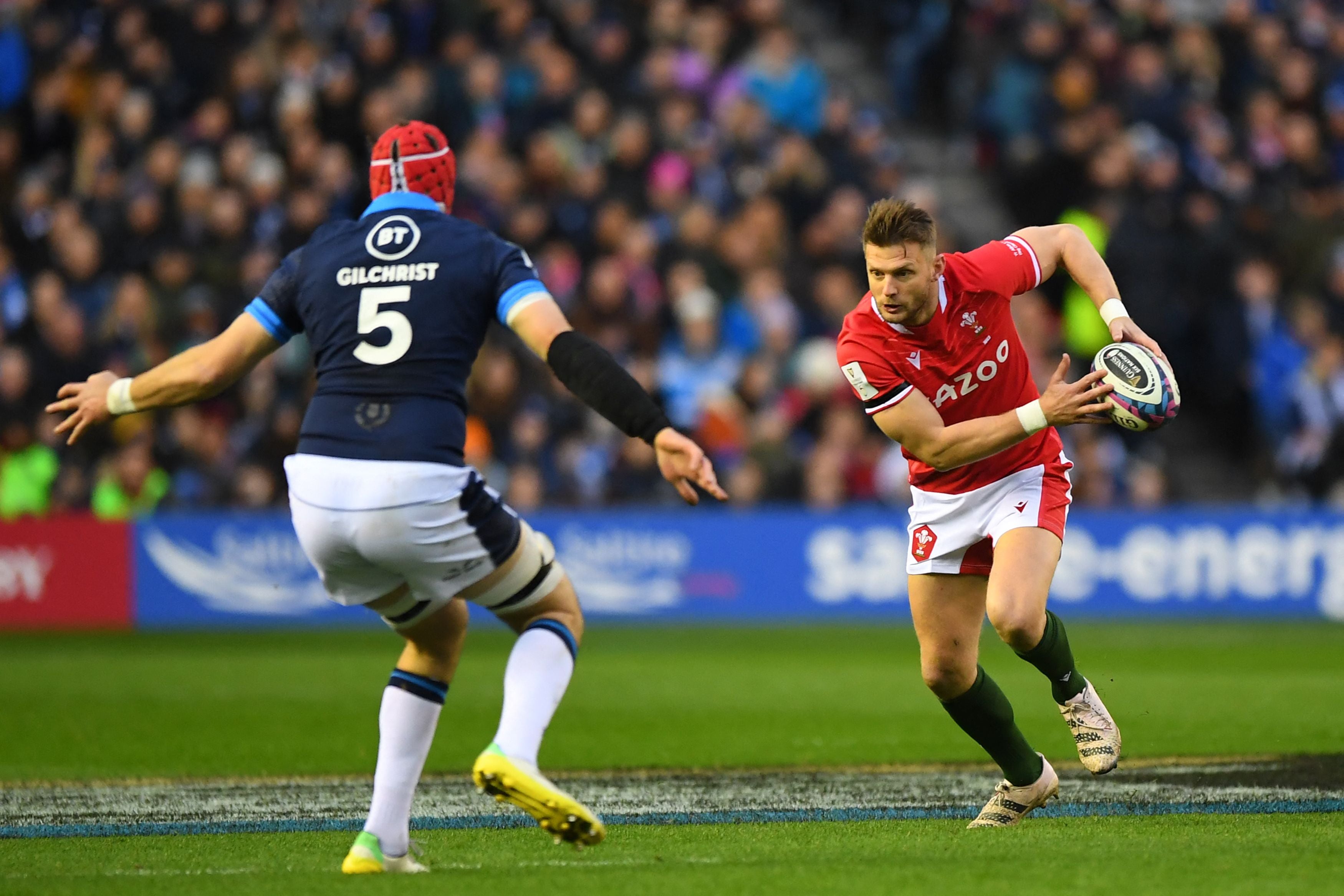 Welsh fly-half Dan Biggar runs at Scotland’s lock Grant Gilchrist during the 2023 Six Nations