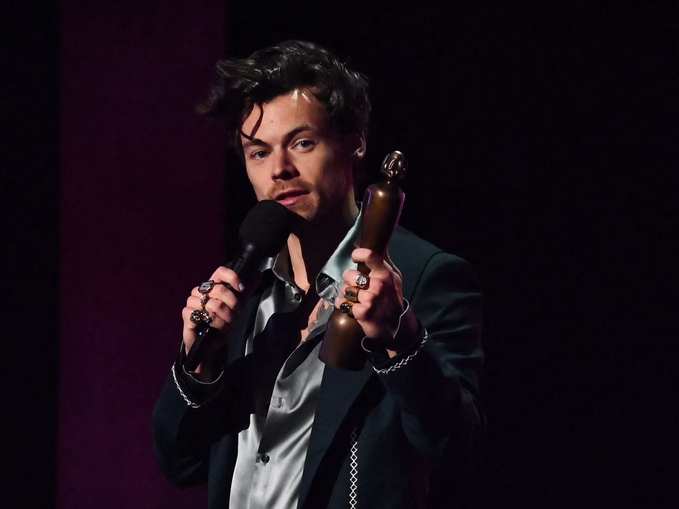 British singer Harry Styles celebrates after receiving the best pop and r&b act of the year award