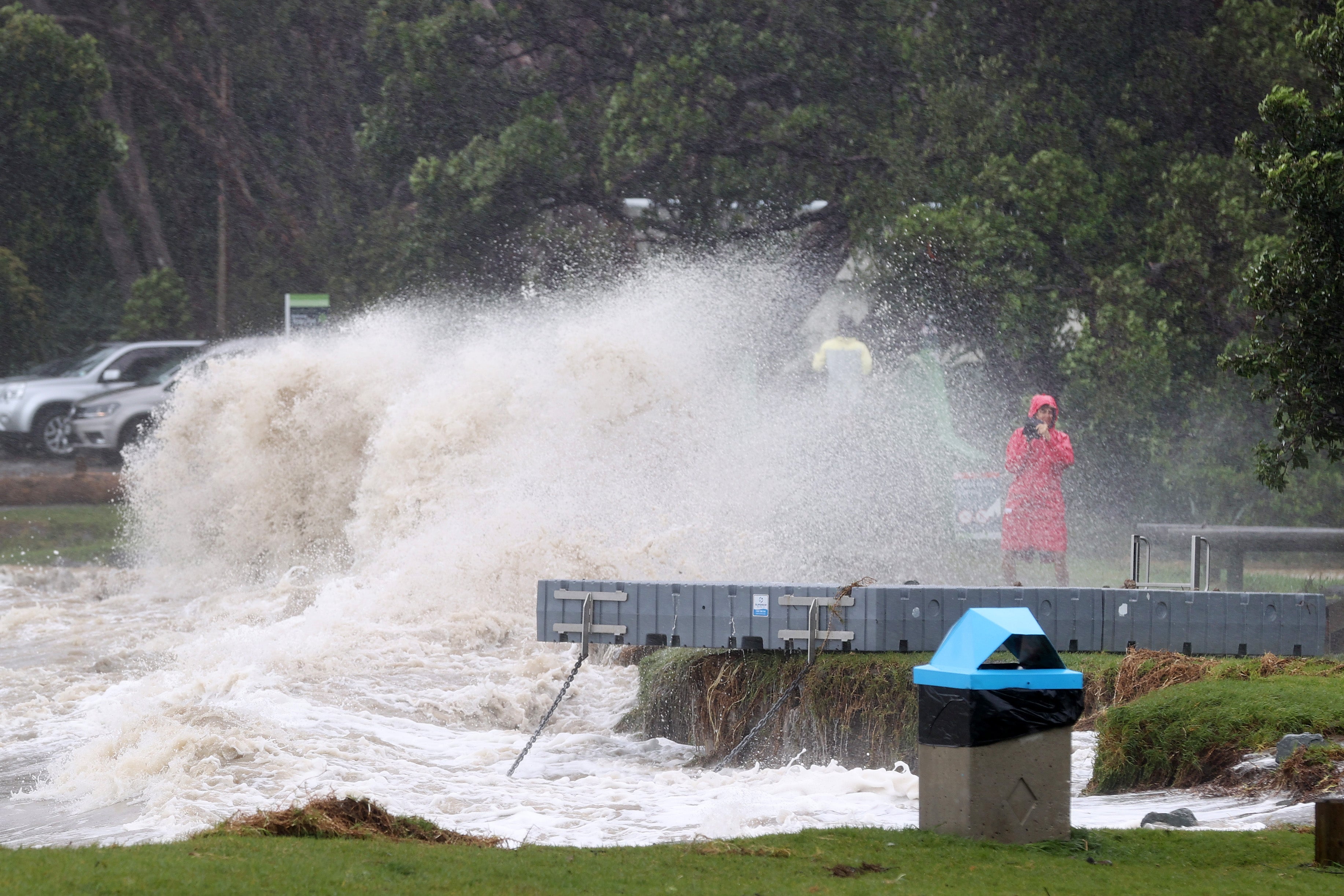 People out looking at the effects of Cyclone Gabrielle at Mathesons Bay Beach on the Matakana Coast