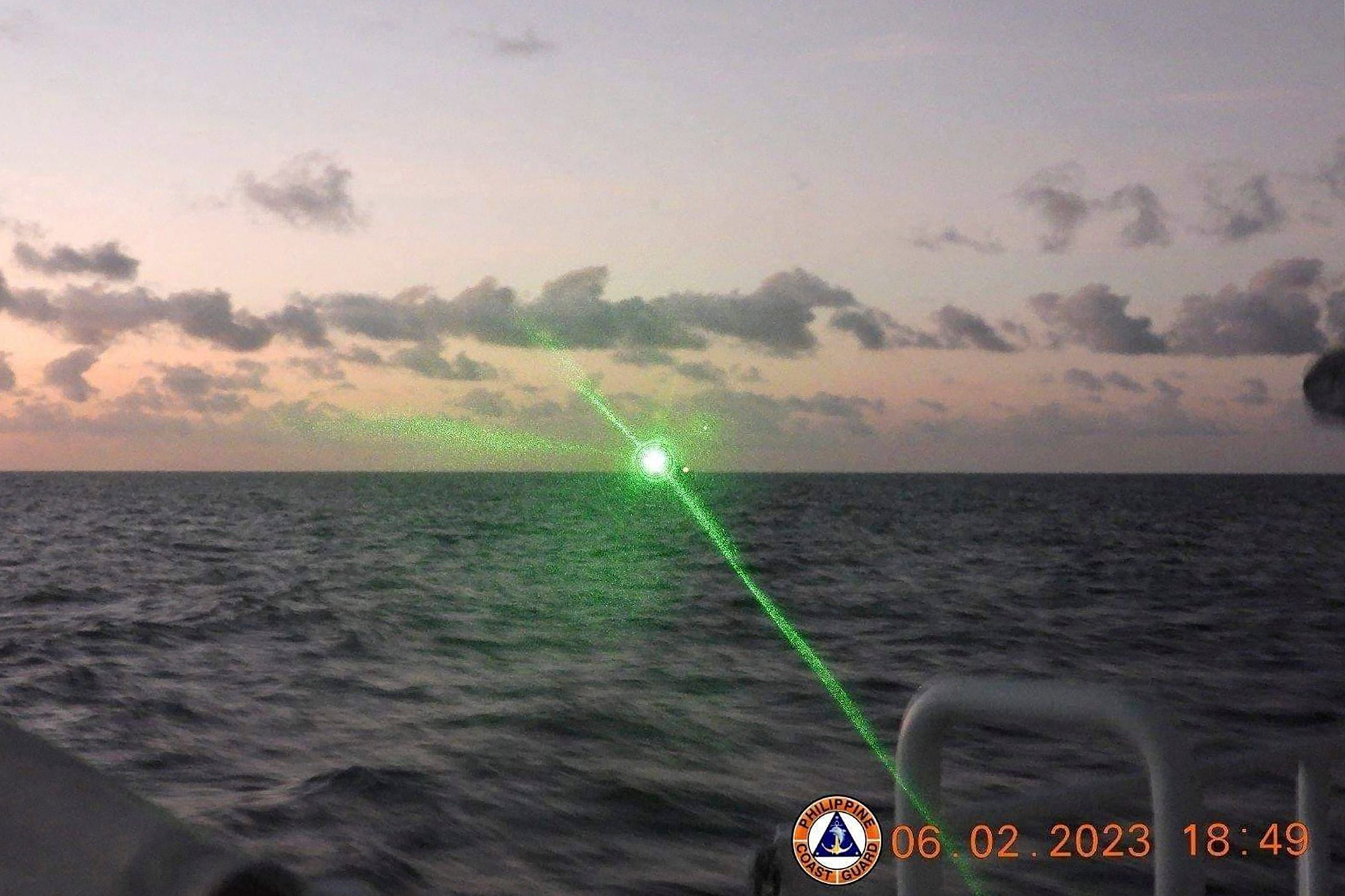 A Chinese Coast Guard vessel shining a ‘military grade laser light' at a Philippine Coast Guard boat