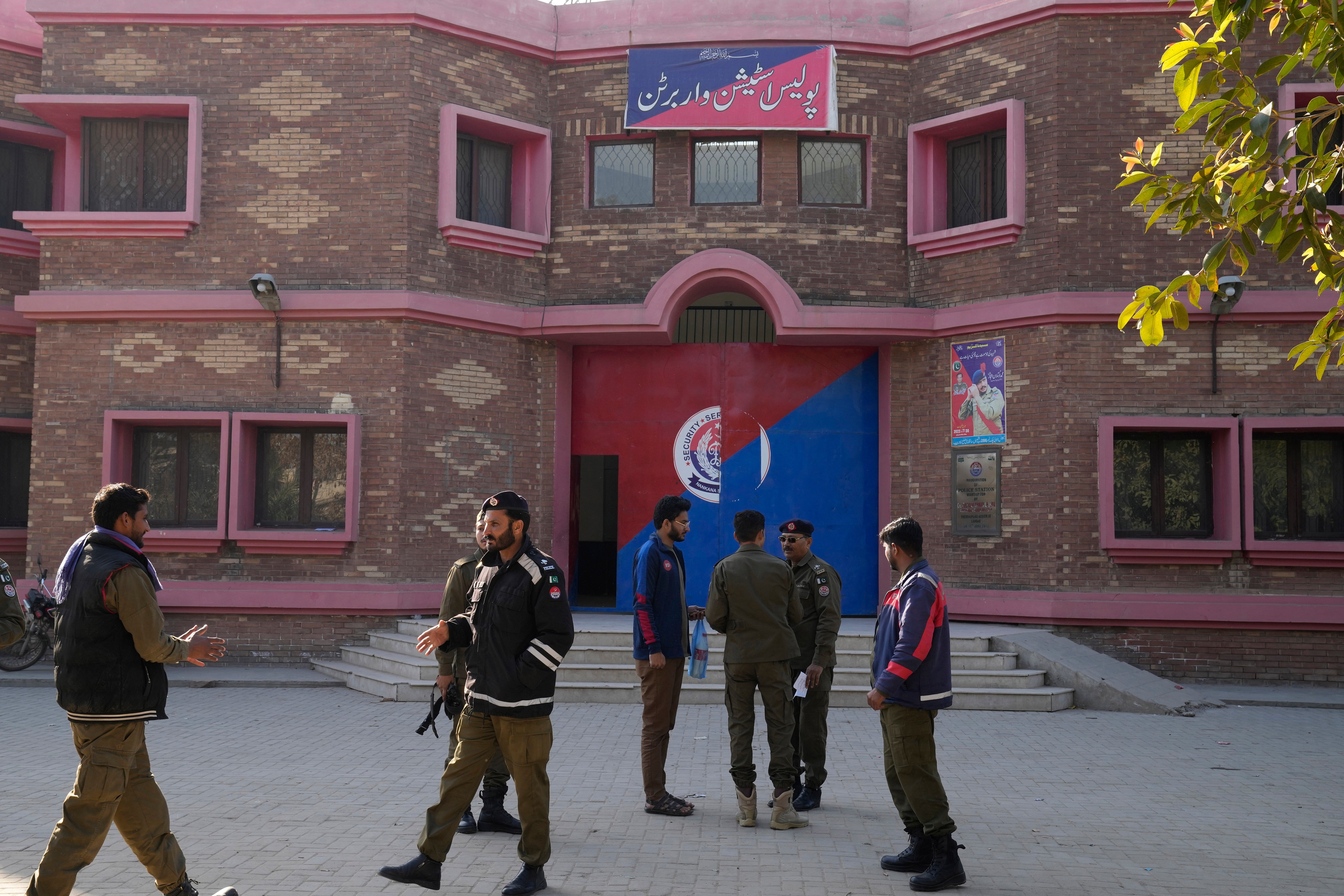 File. Police officers gather outside a police station, in Warburton, an area of district Nankana, Pakistan, Sunday, 12 February 2023. Hundreds of Muslims descended on a police station in Pakistan's eastern Punjab province, snatched Waris, a blasphemy suspect from his cell and took him outside and lynched him, police said