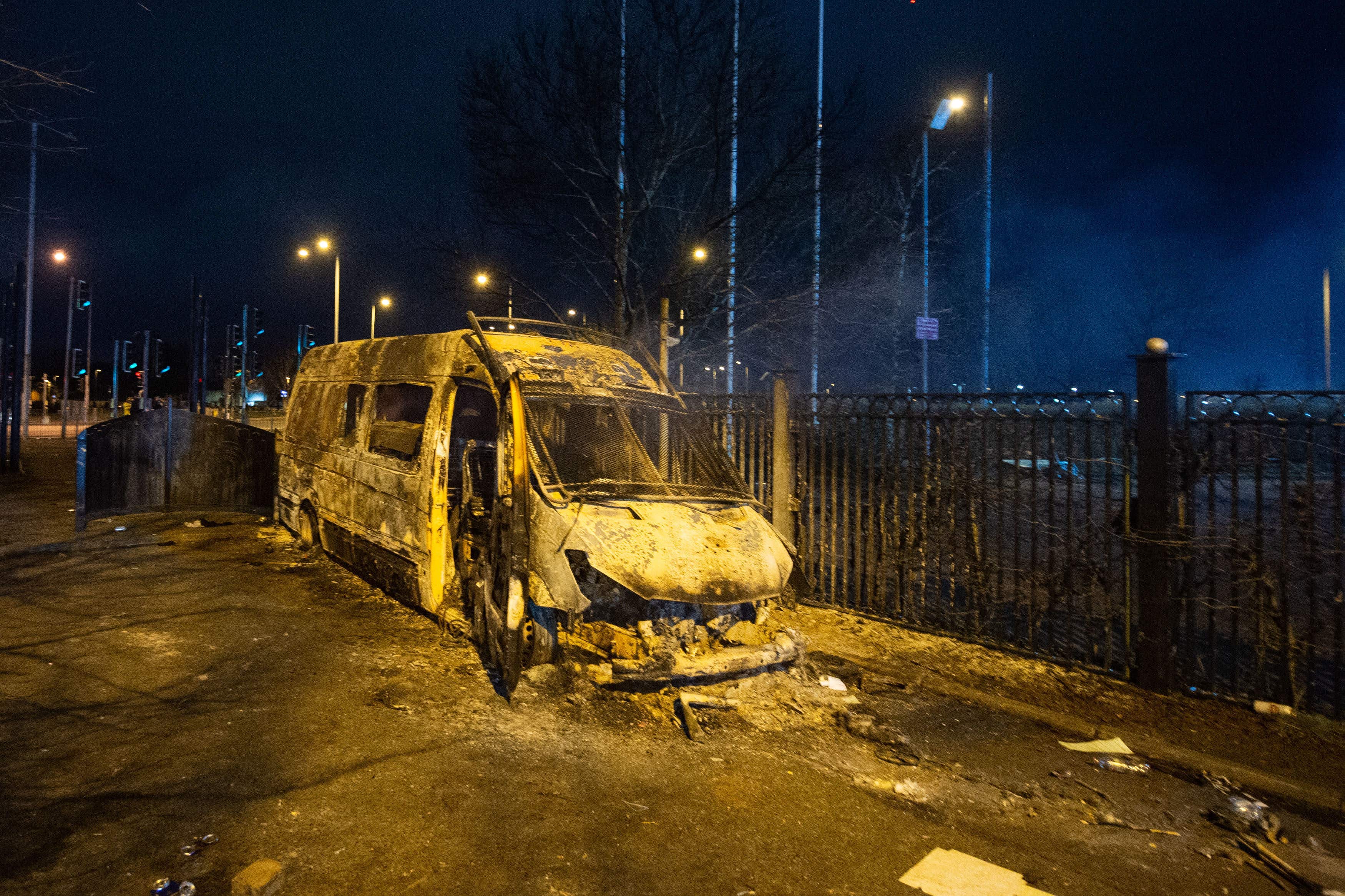 A police van was destroyed during the protest outside the Suites Hotel in Knowsley