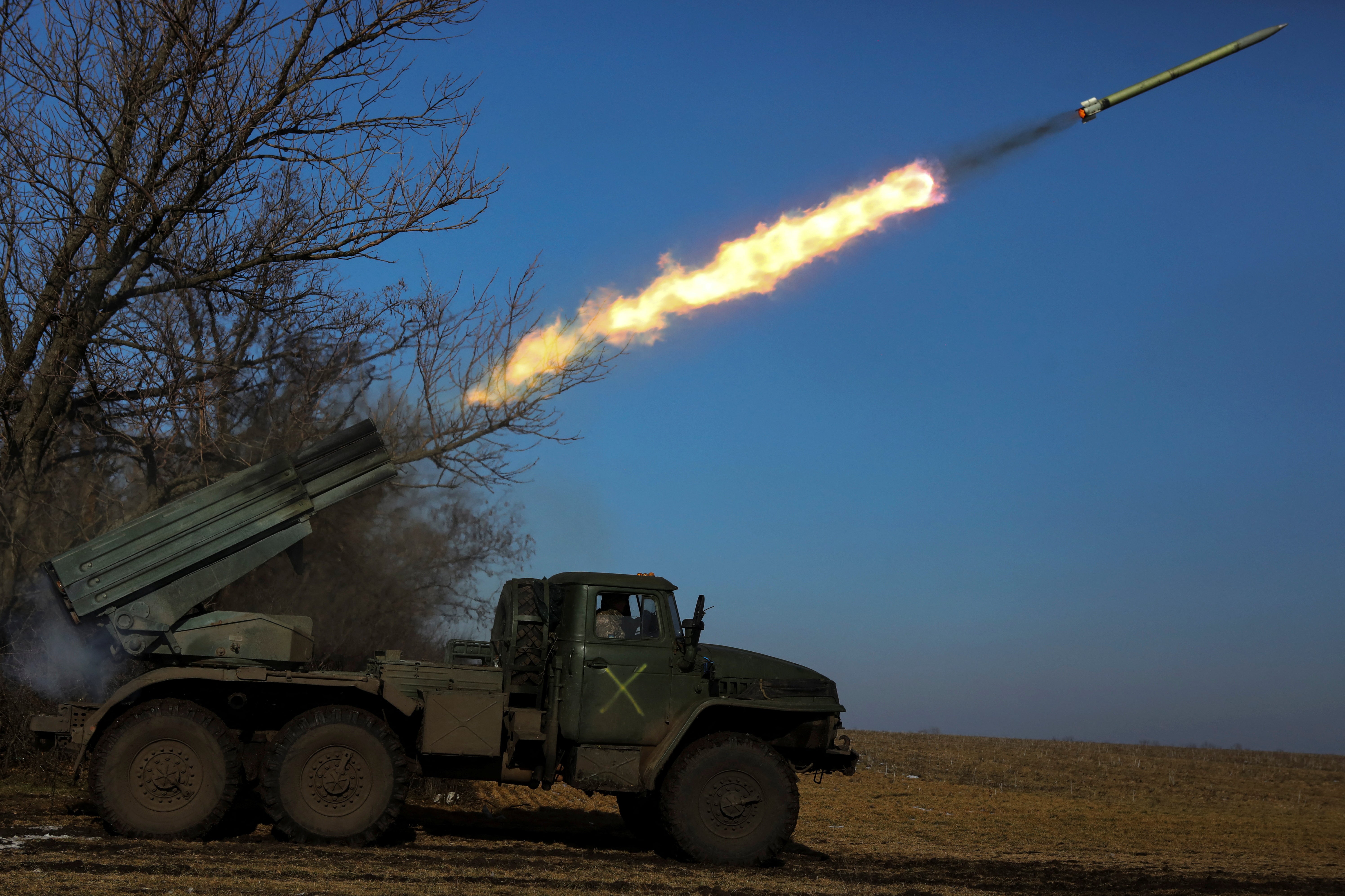 Ukrainian troops fire a BM-21 Grad multiple launch rocket system towards Russian positions in Donetsk