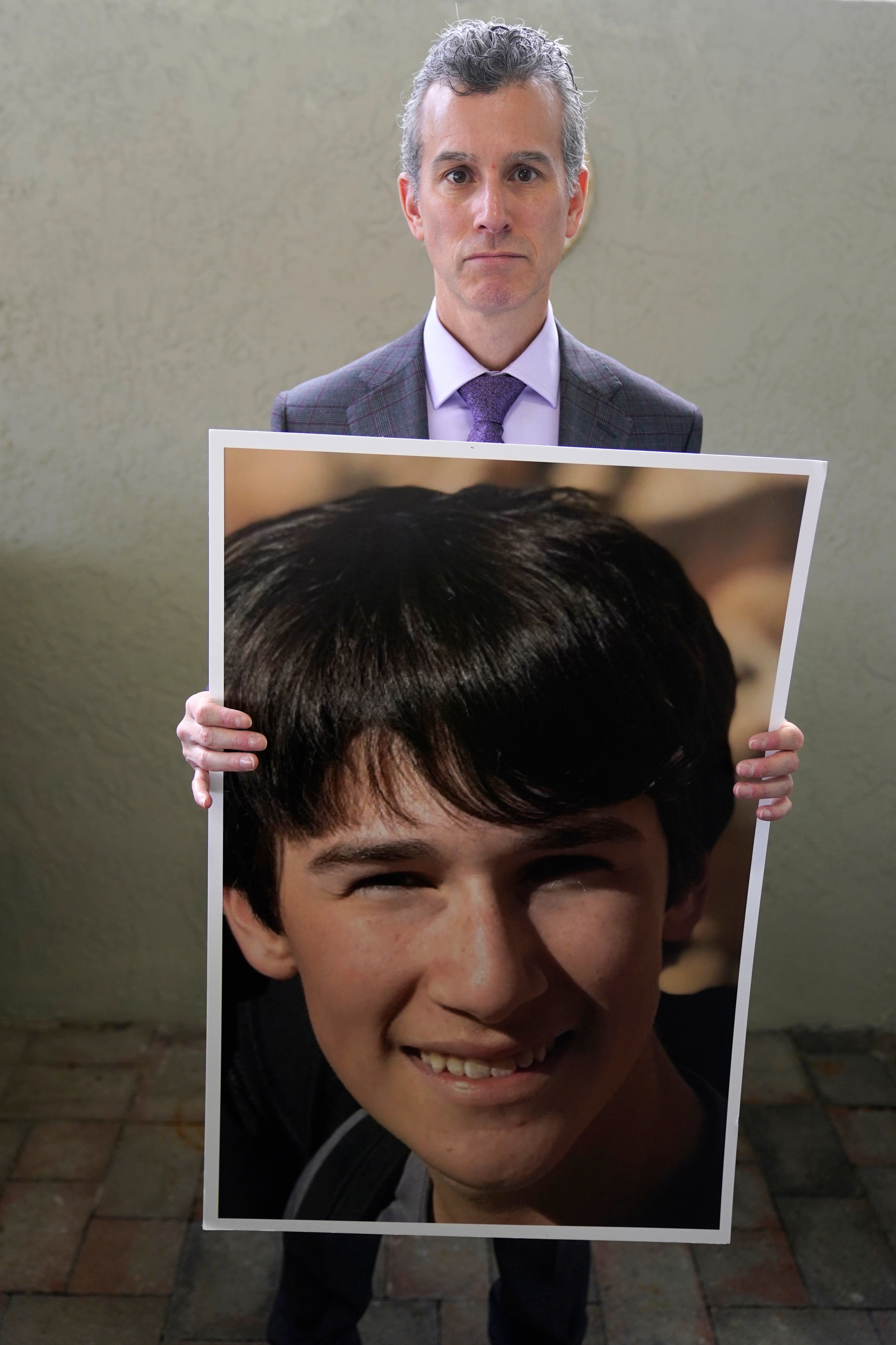 Max Schachter holds up a photo of his 14-year-old son Alex