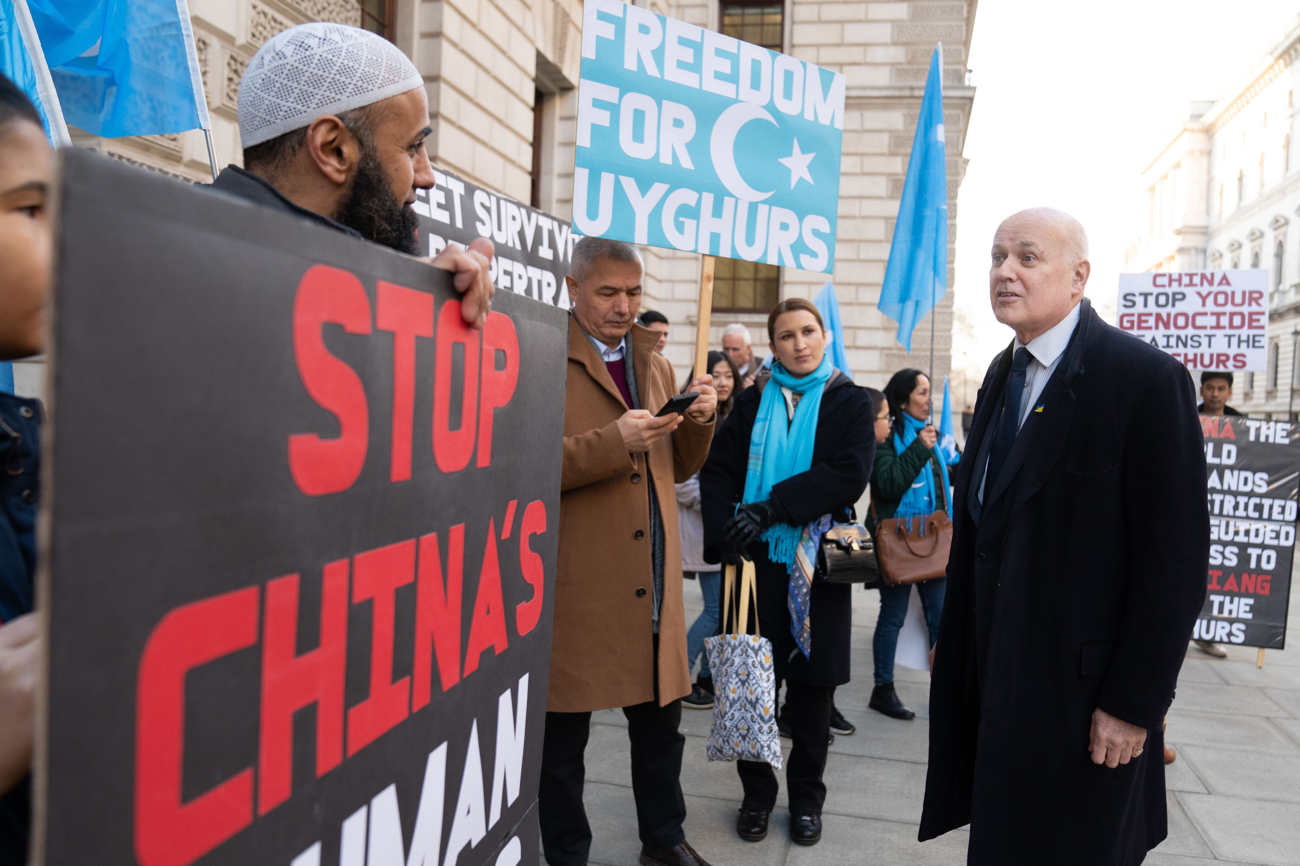 Sir Iain Duncan Smith (right) joins a vigil taking place outside the Foreign Office