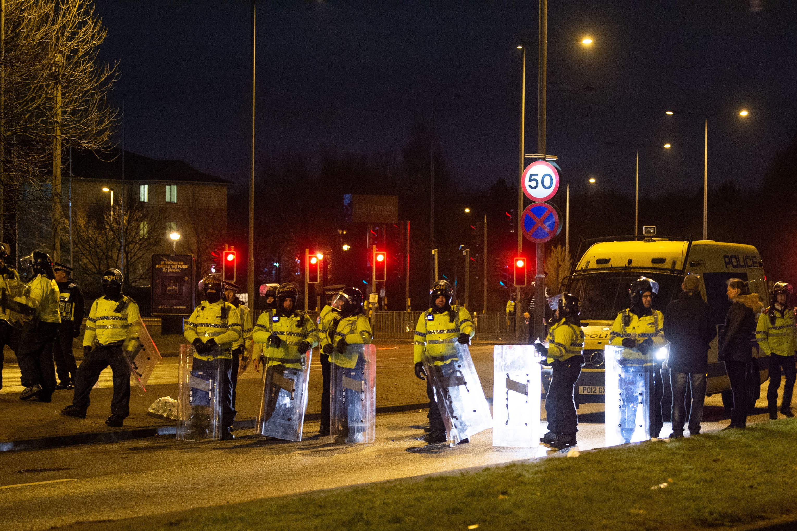 Police in riot gear after a demonstration outside the Suites Hotel in Knowsley