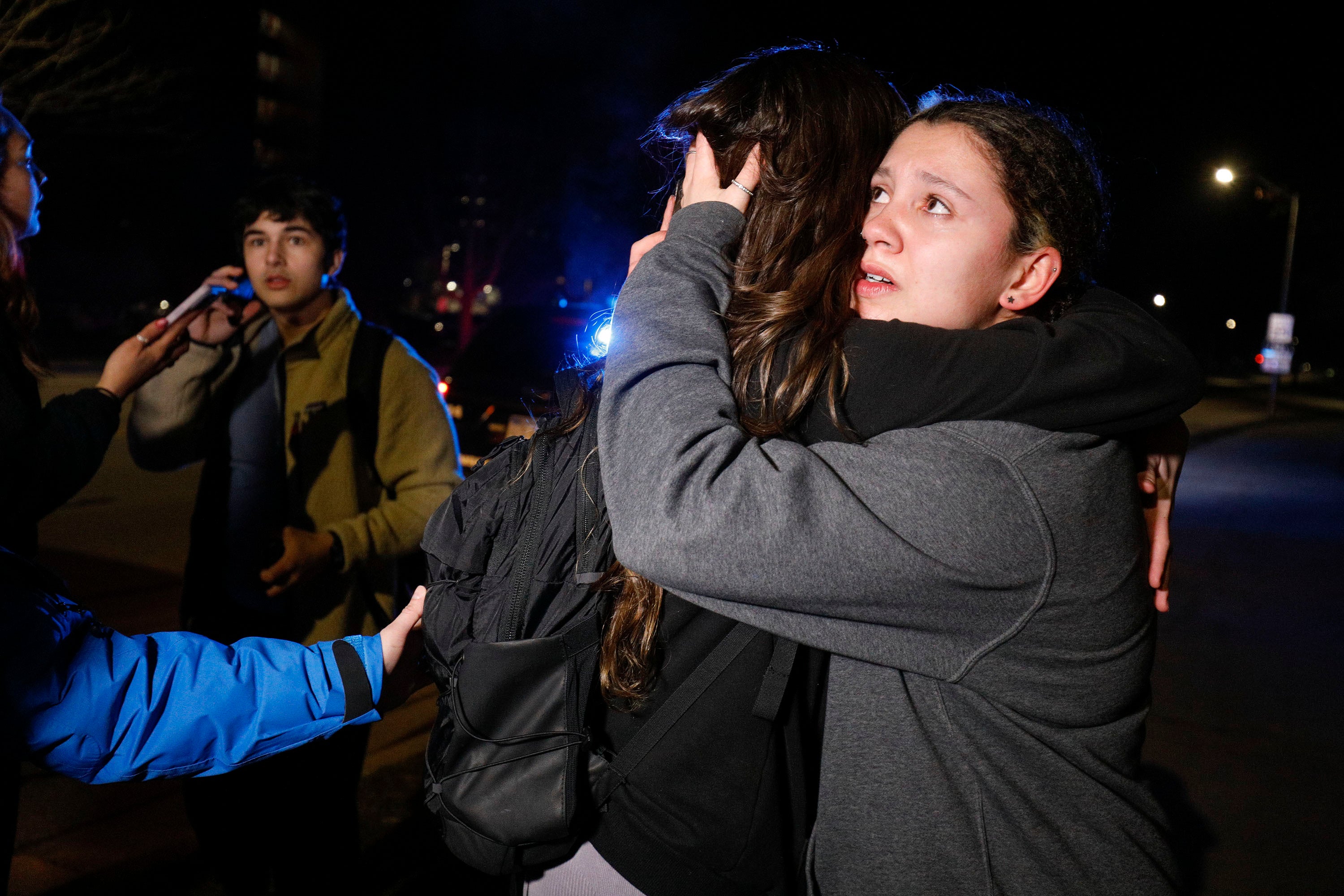 Michigan State University students hug during an active shooter situation on campus on 13 February 2023 in Lansing, Michigan