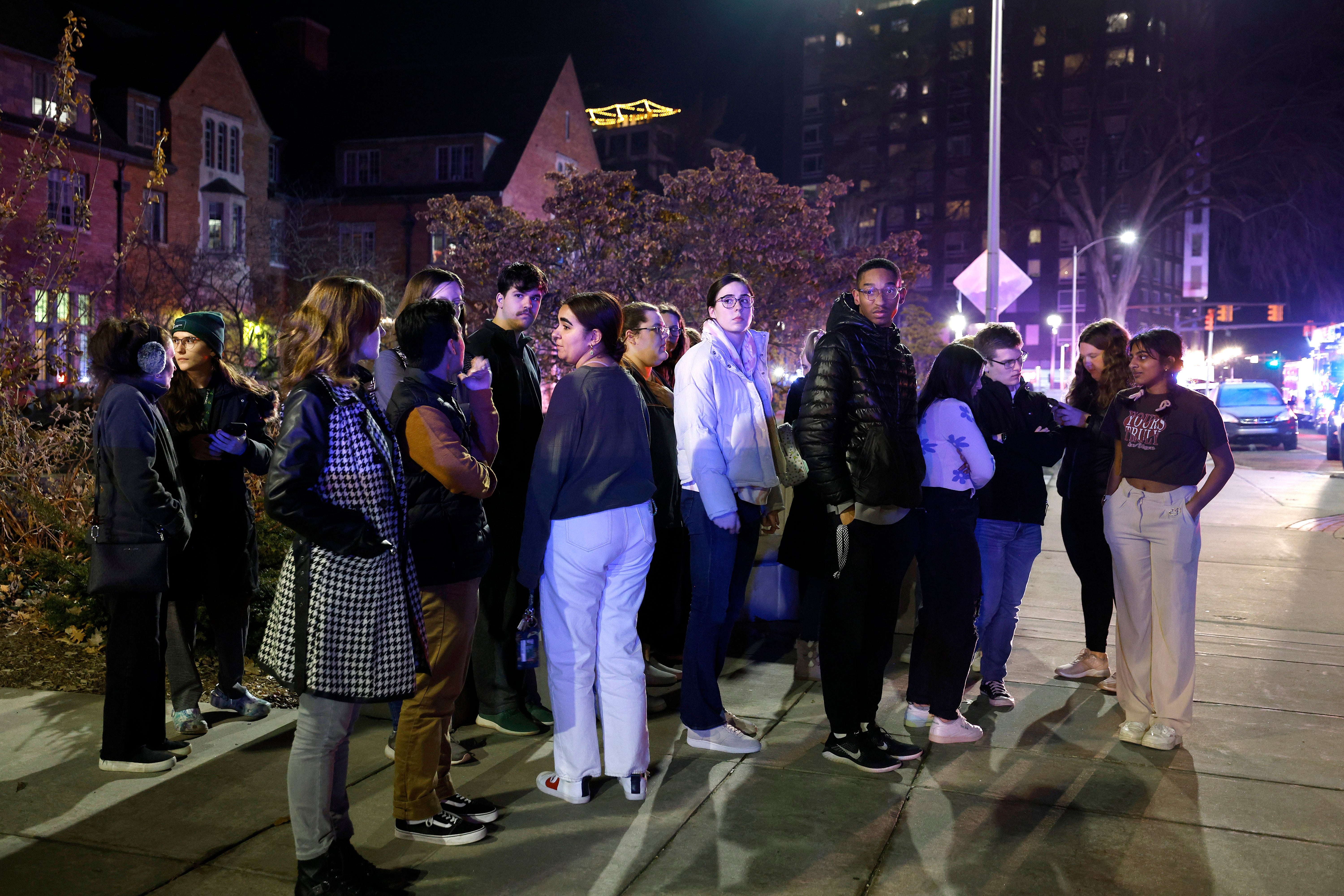 Students gather near the East Lansing campus after Monday night’s shooting