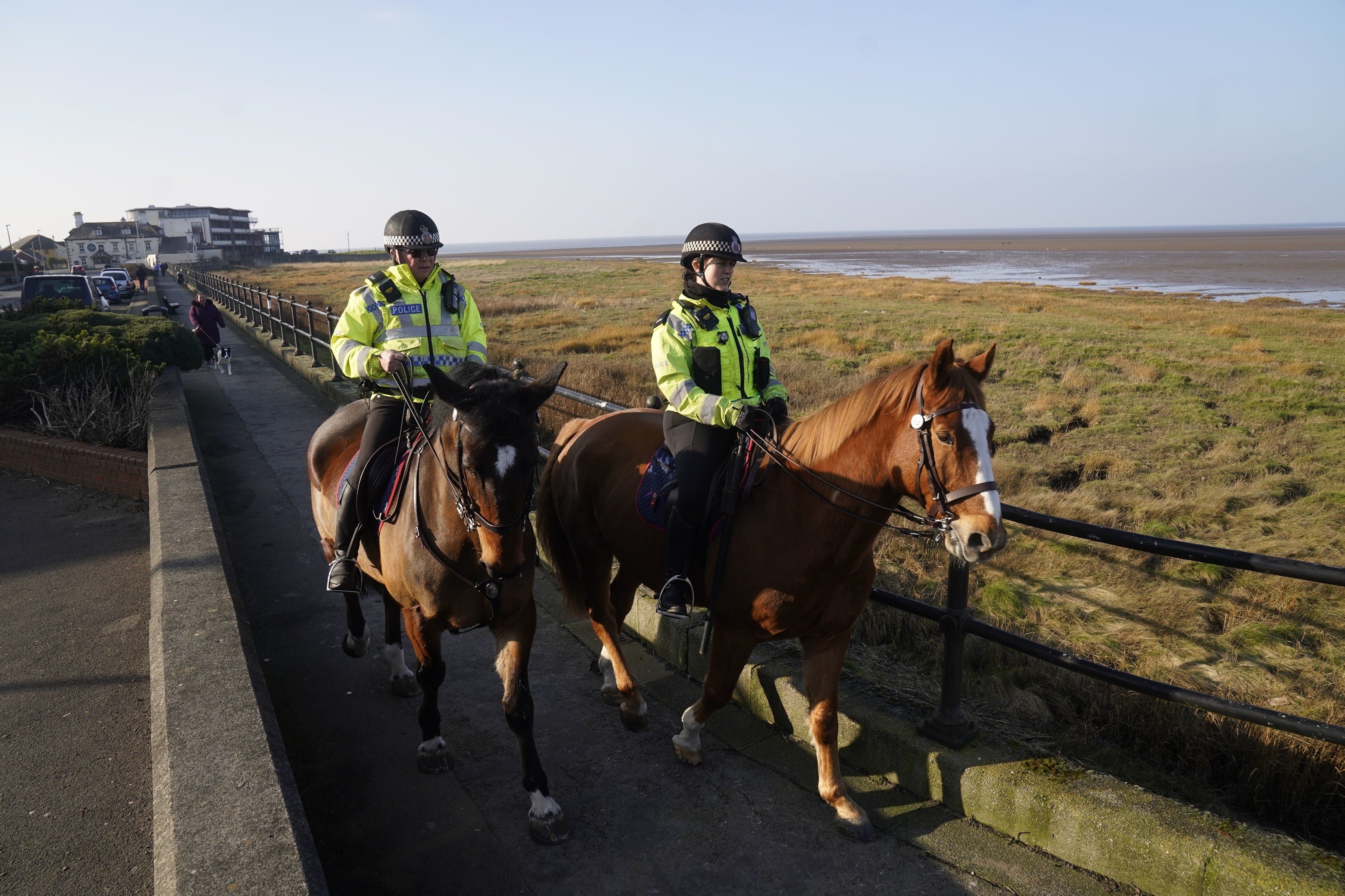 Mounted police in Knott End-on-Sea take part in the search for Ms Bulley