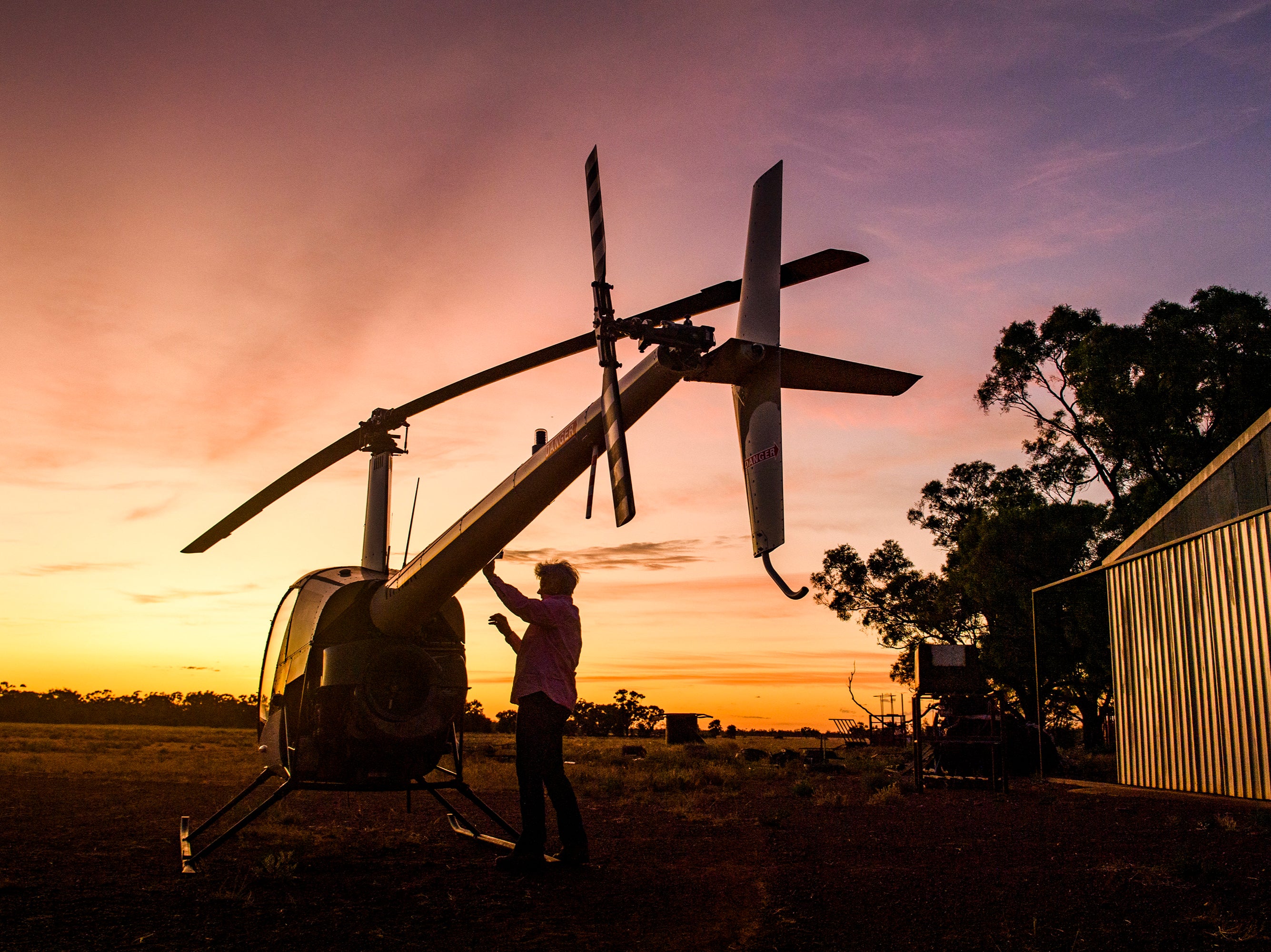 Carol Godfrey prepares her Robinson 22 at first light to inspect the vast property where she manages cattle and a carbon project