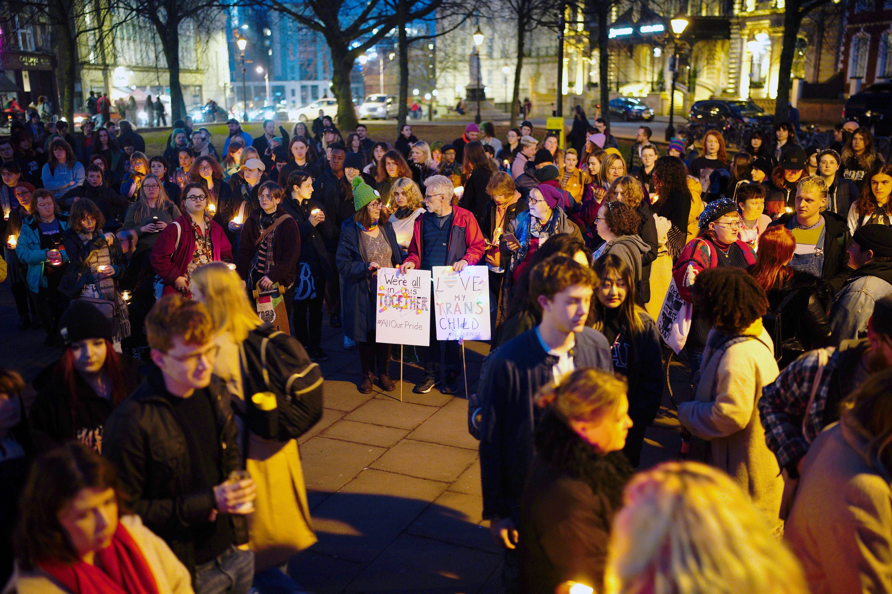 Members of the public attend a candle-lit vigil at College Green in Bristol