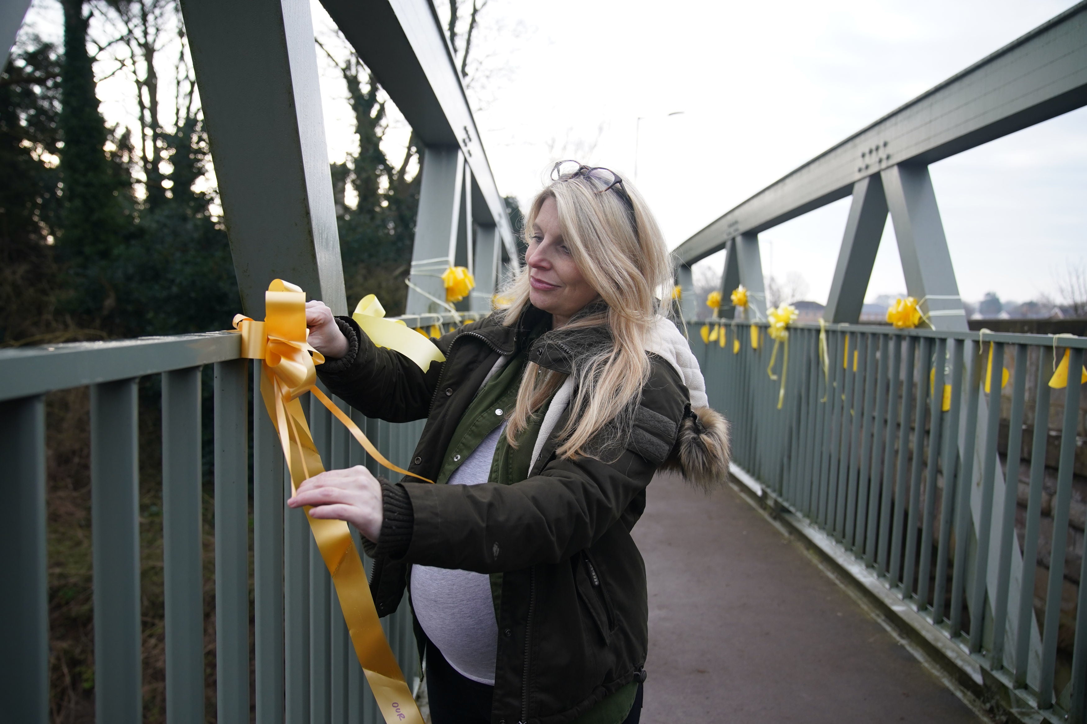 Friends tied yellow ribbons on a bridge over the river as the search continues