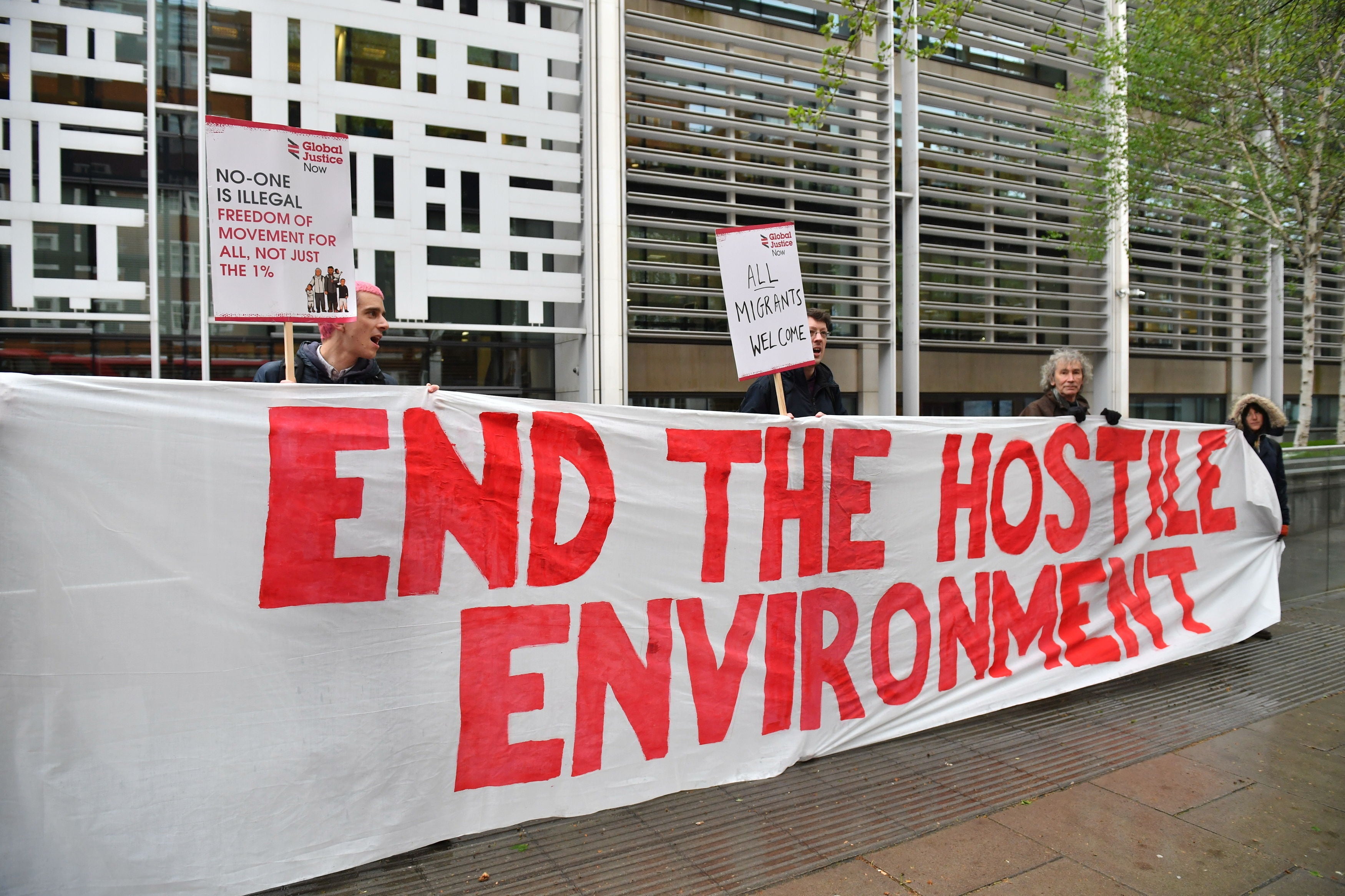 Demonstrators protest against the hostile environment immigration policy outside the Home Office in Westminster, London