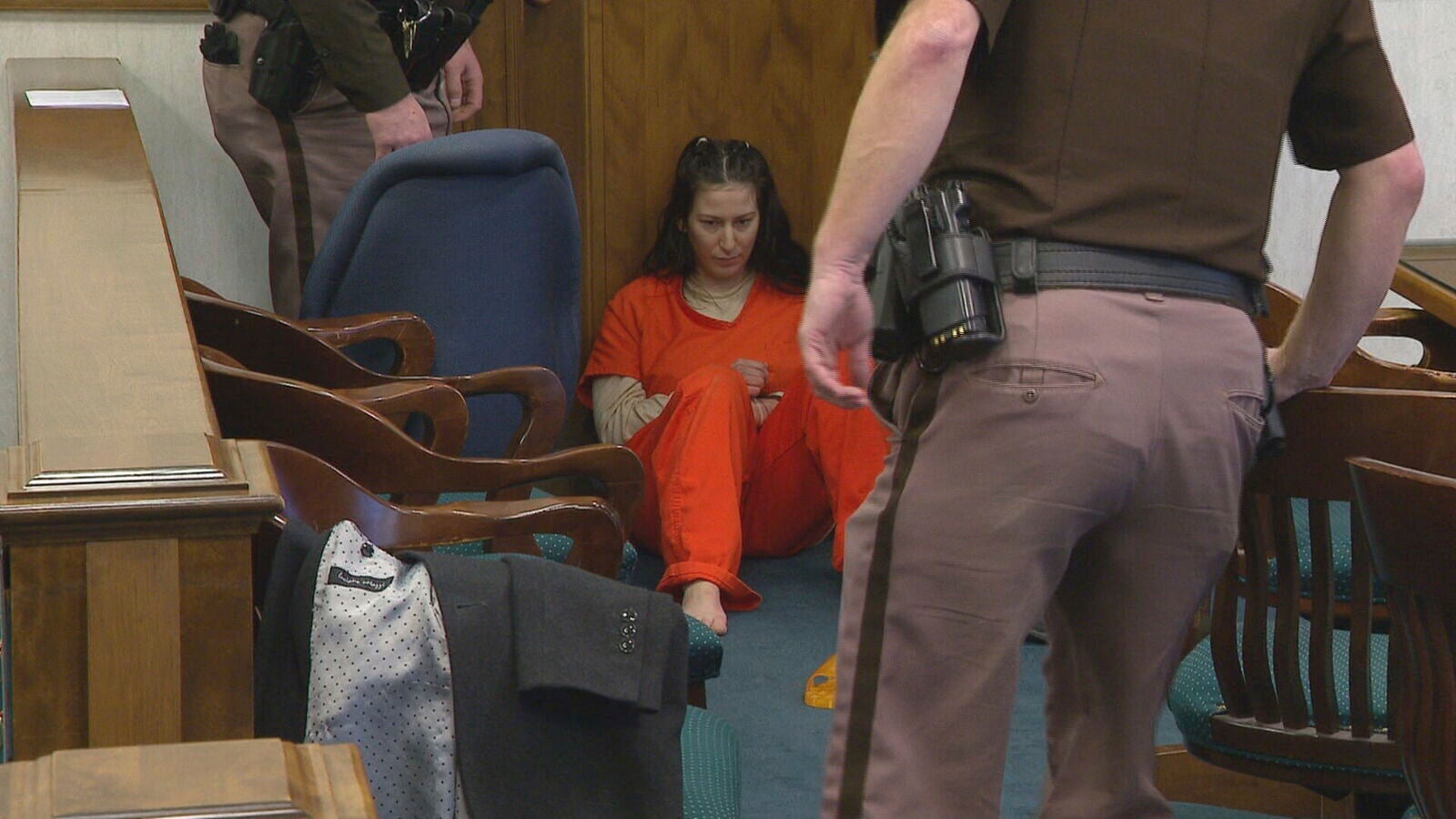 Taylor Schabusiness sits on the floor of a Brown County courtroom after attacking her attorney, Quinn Jolly, during a court hearing in Green Bay, Wis., on Tuesday, Feb. 14, 2023