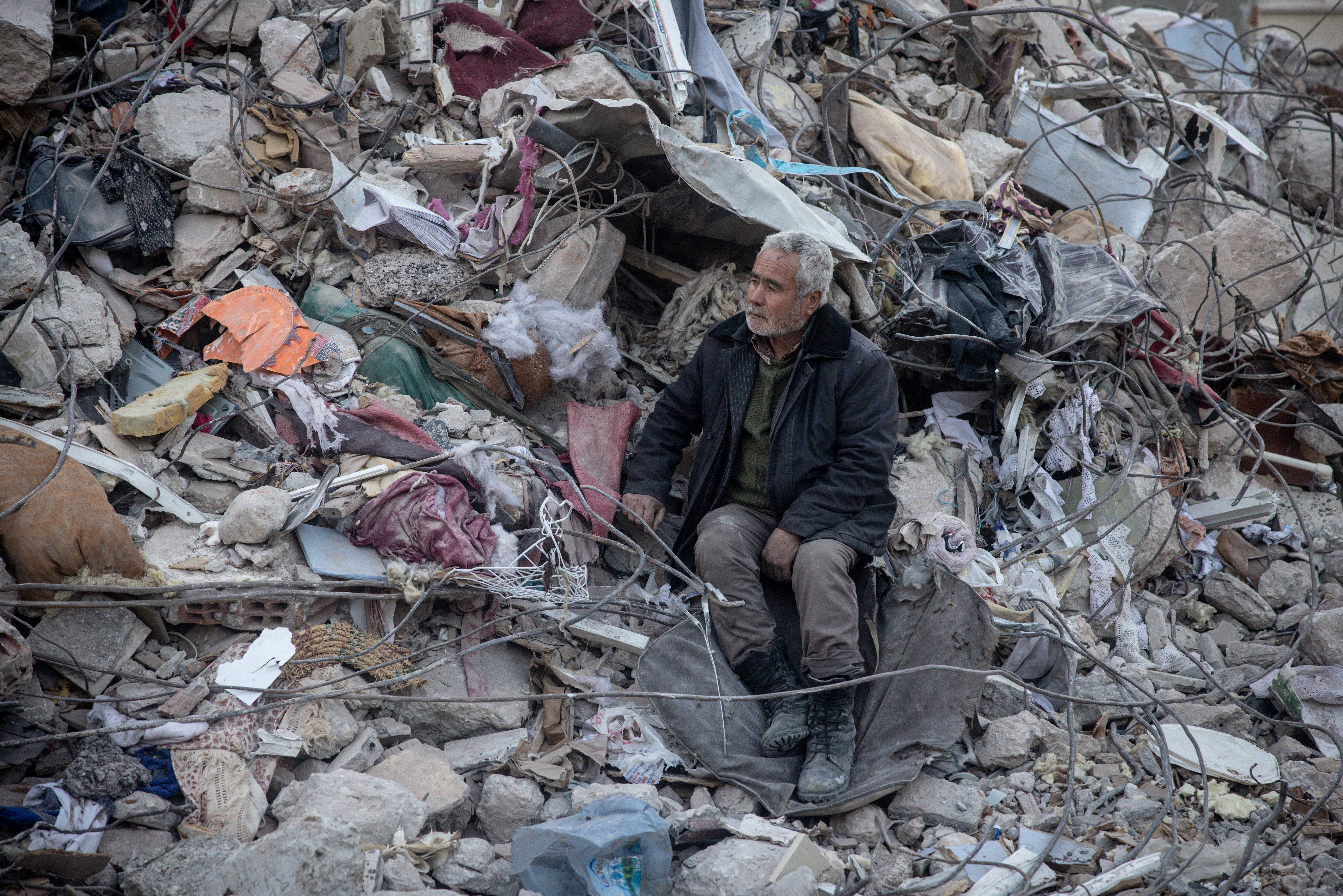 A man watches a search and rescue operation in Hatay, Turkey on Wednesday