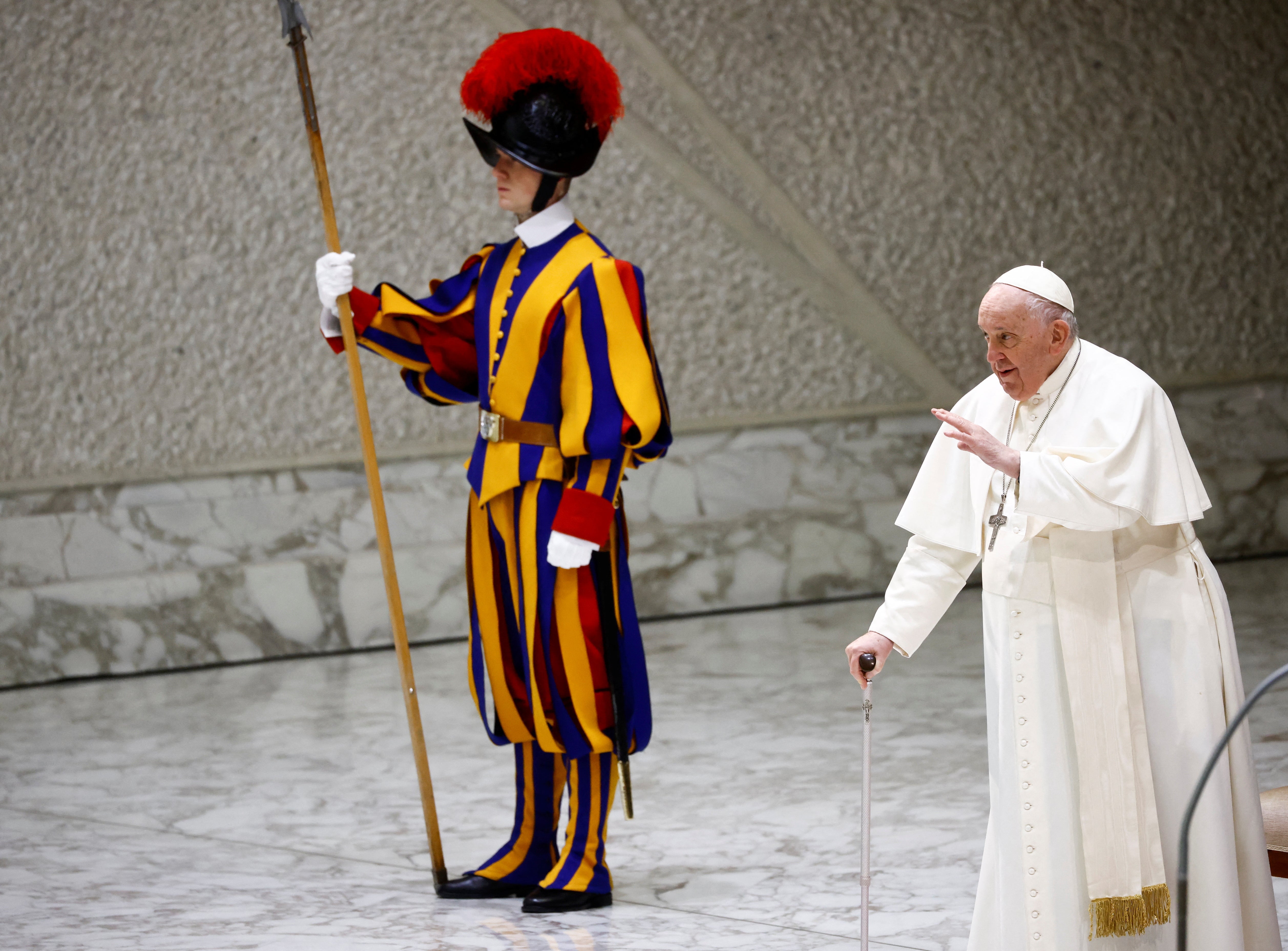 Pope Francis walks with a stick at the Vatican on Wednesday