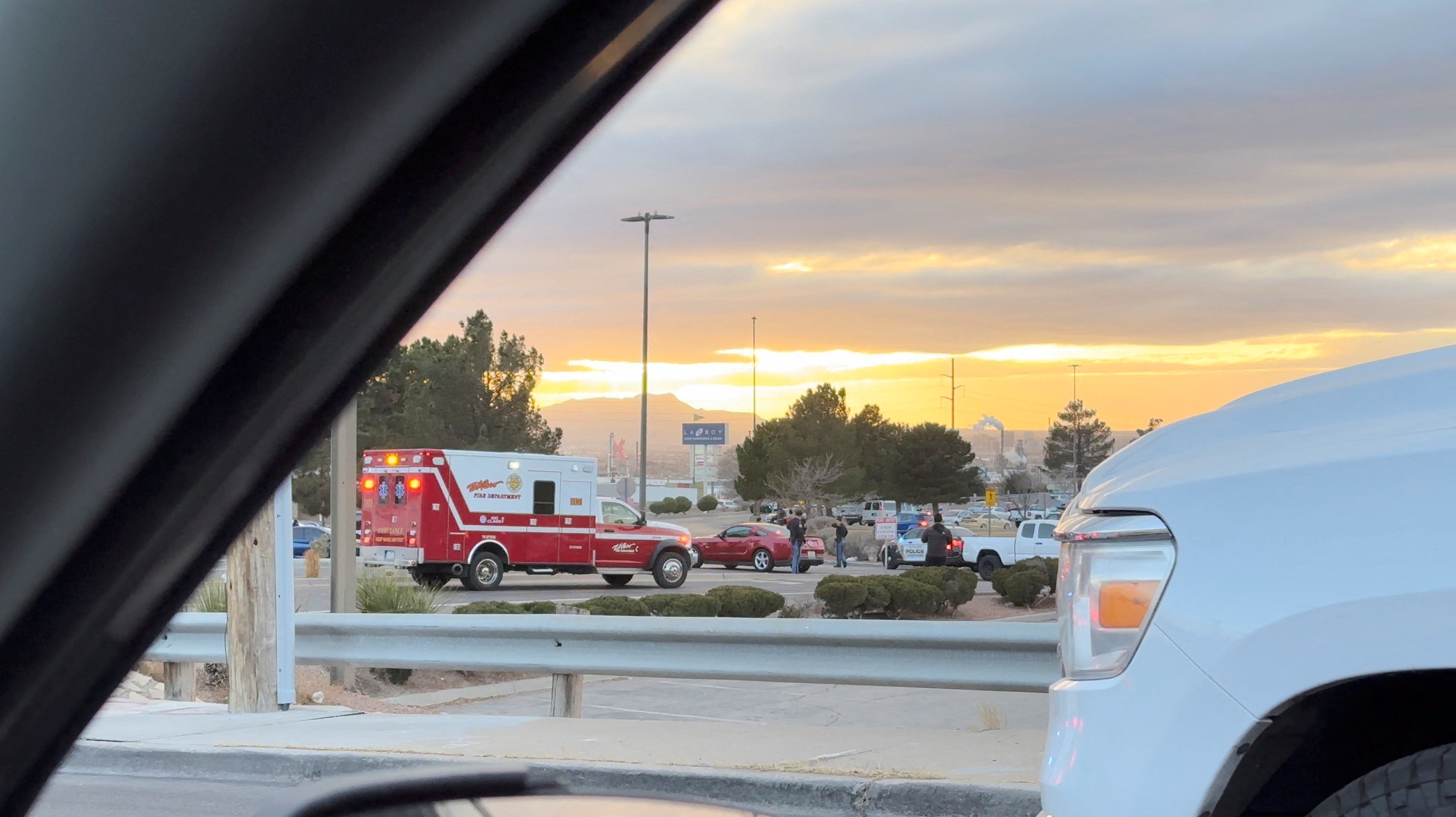 An ambulance arrives as law enforcement officials stand outside the Cielo Vista Mall