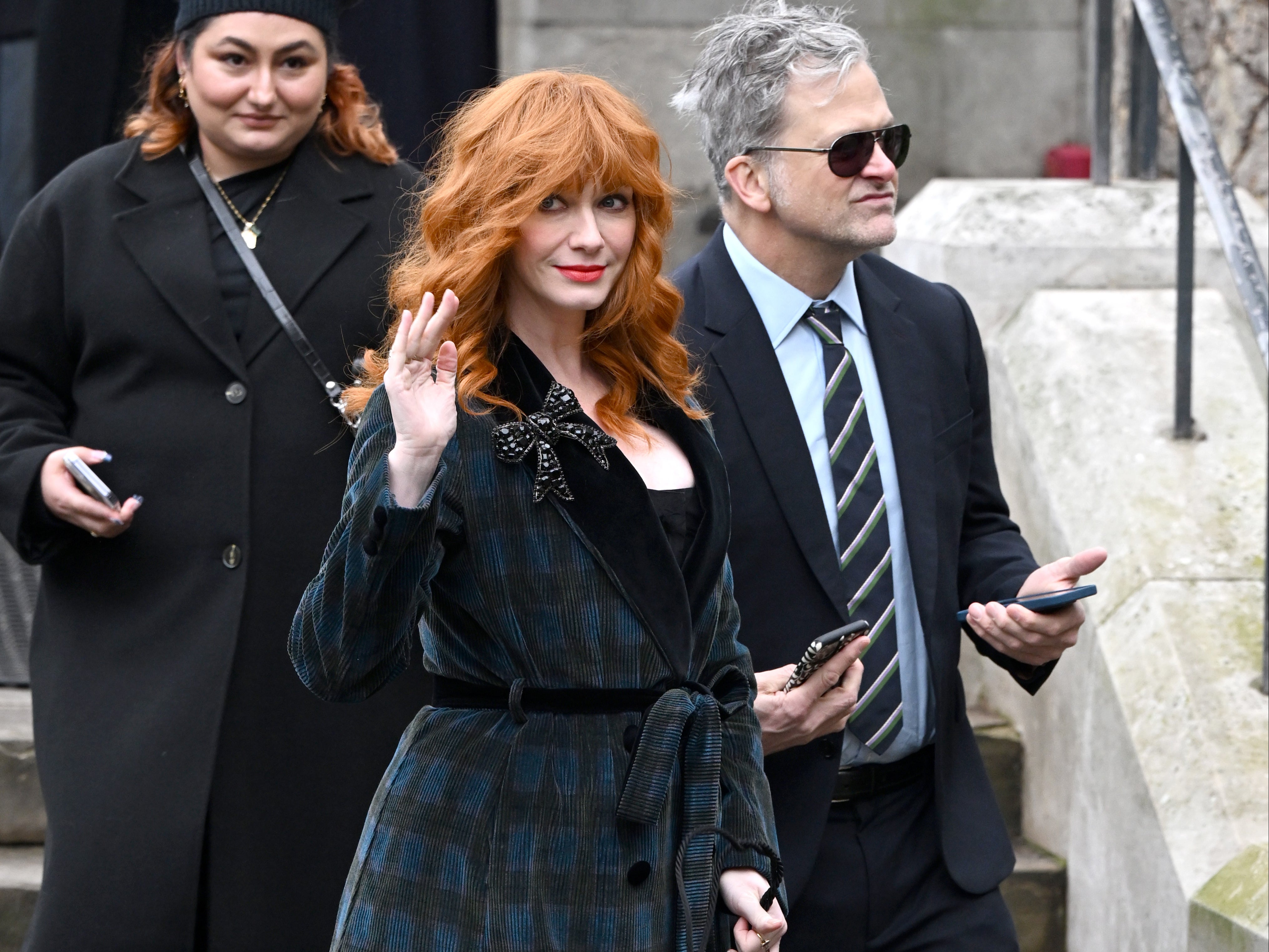 Christina Hendricks waves as she attends a memorial service to honour and celebrate the life of Dame Vivienne Westwood at Southwark Cathedral