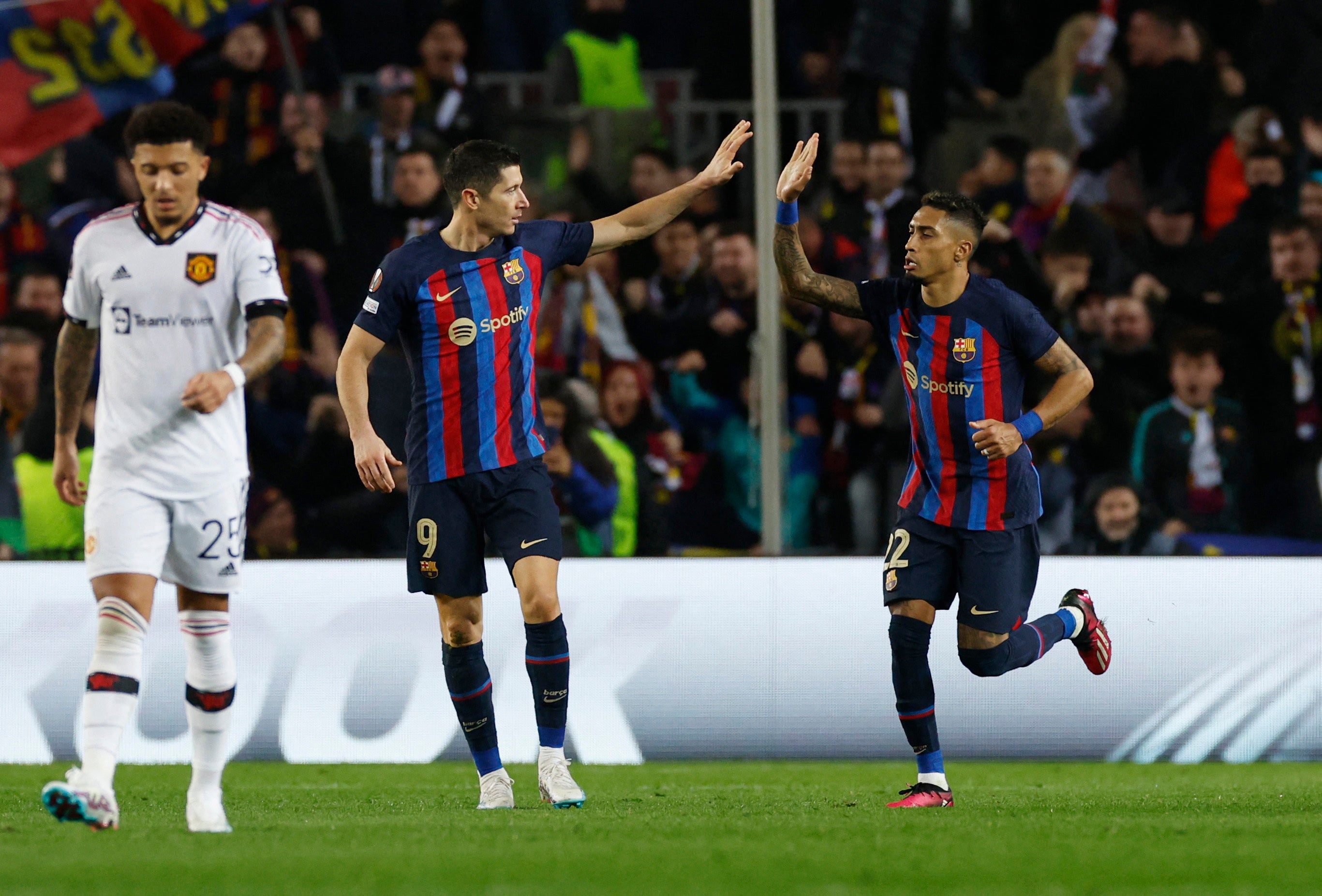 Raphinha, right, celebrates scoring their second goal with Robert Lewandowski