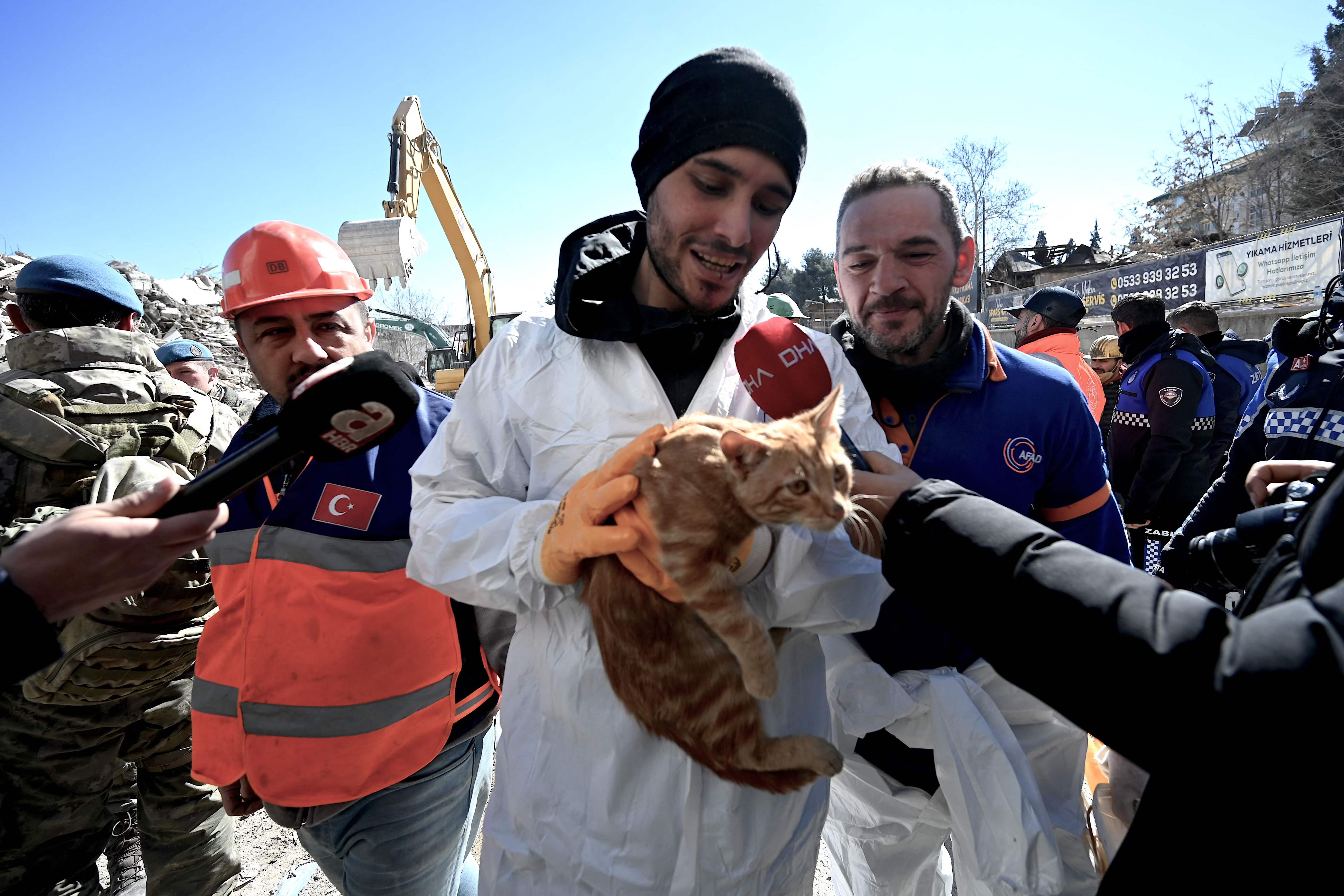 A volunteer shows a cat rescued from a collapsed building in Turkey on Thursday