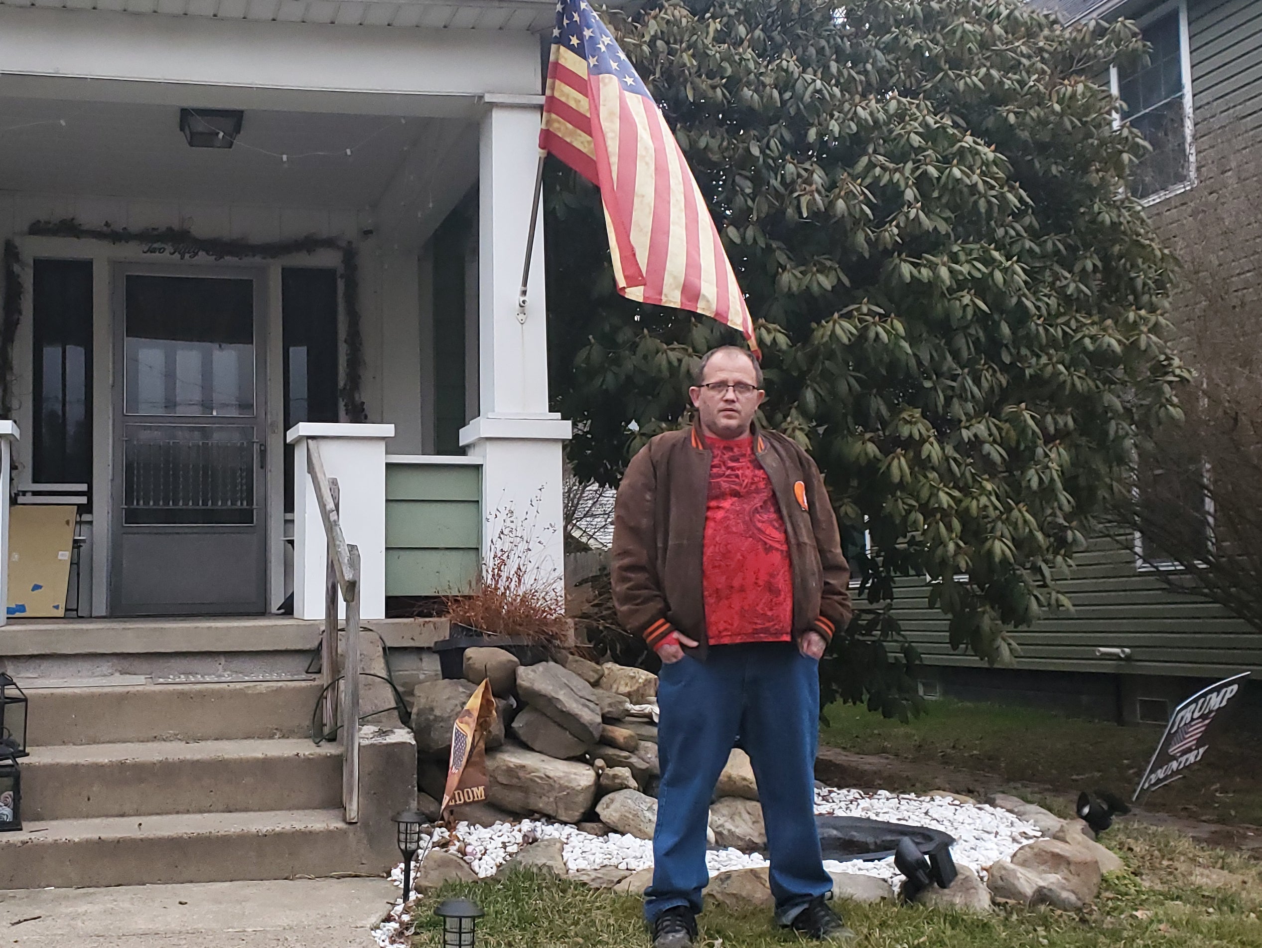 Eric Cozza stands outside his East Palestine home, less than a half a mile from where a Norfolk Southern train derailed