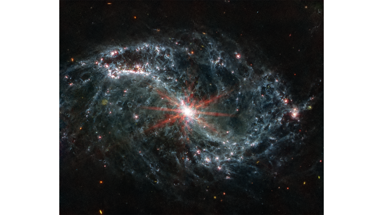 The spiral arms of NGC 7496 are filled with cavernous bubbles and shells overlapping one another in this image from MIRI