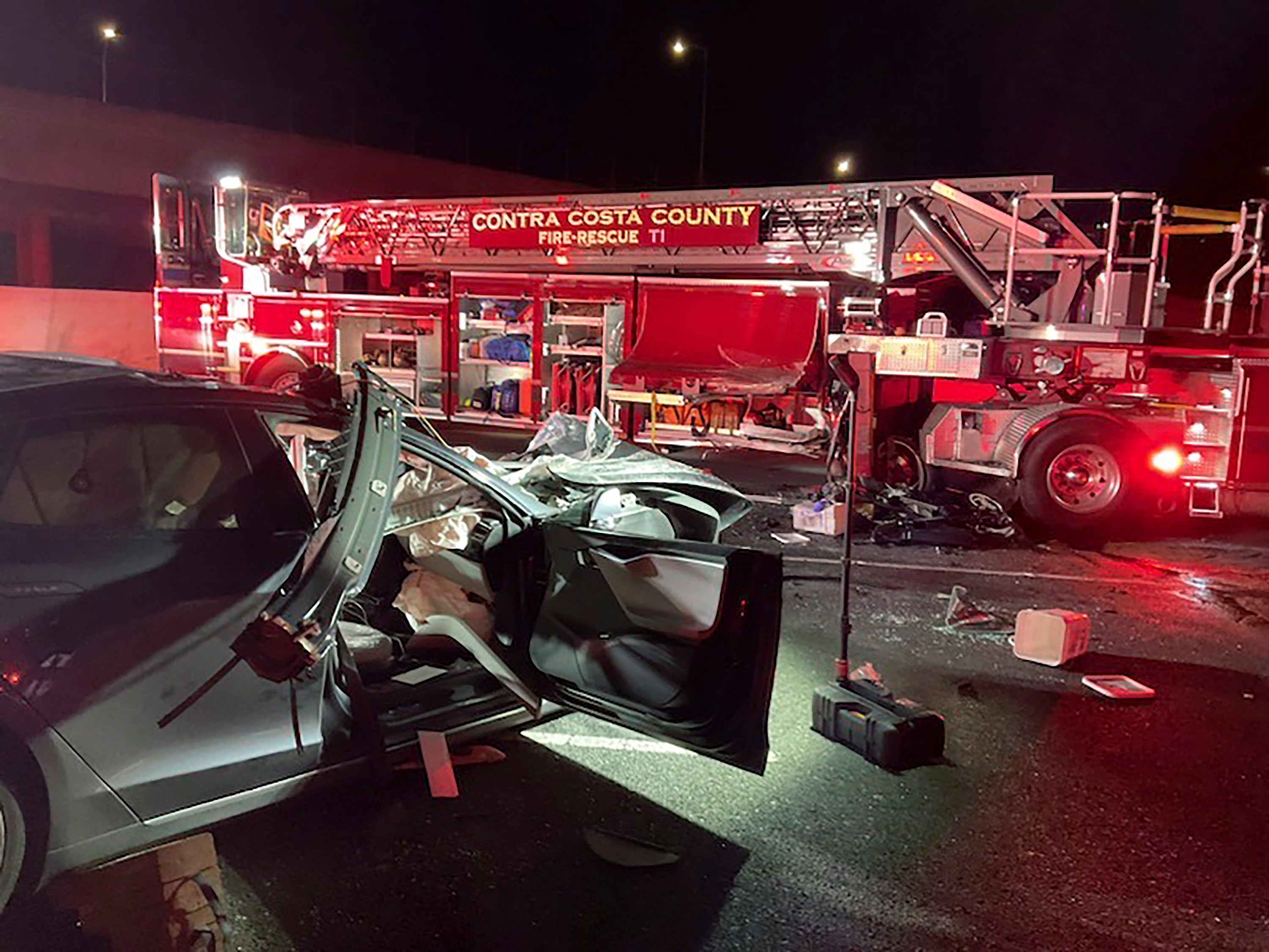 This photo released by Contra Costa County Fire Protection District shows the scene of a fatal accident involving a Tesla and Contra Costa County fire truck early Saturday morning, Feb. 18, 2023, in Contra Costa, Calif. Fire officials said the Tesla driver was killed and a passenger was critically injured Saturday when the car plowed into the fire truck parked on a Northern California freeway to shield a crew clearing another accident. (Contra Costa County Fire Protection District via AP)