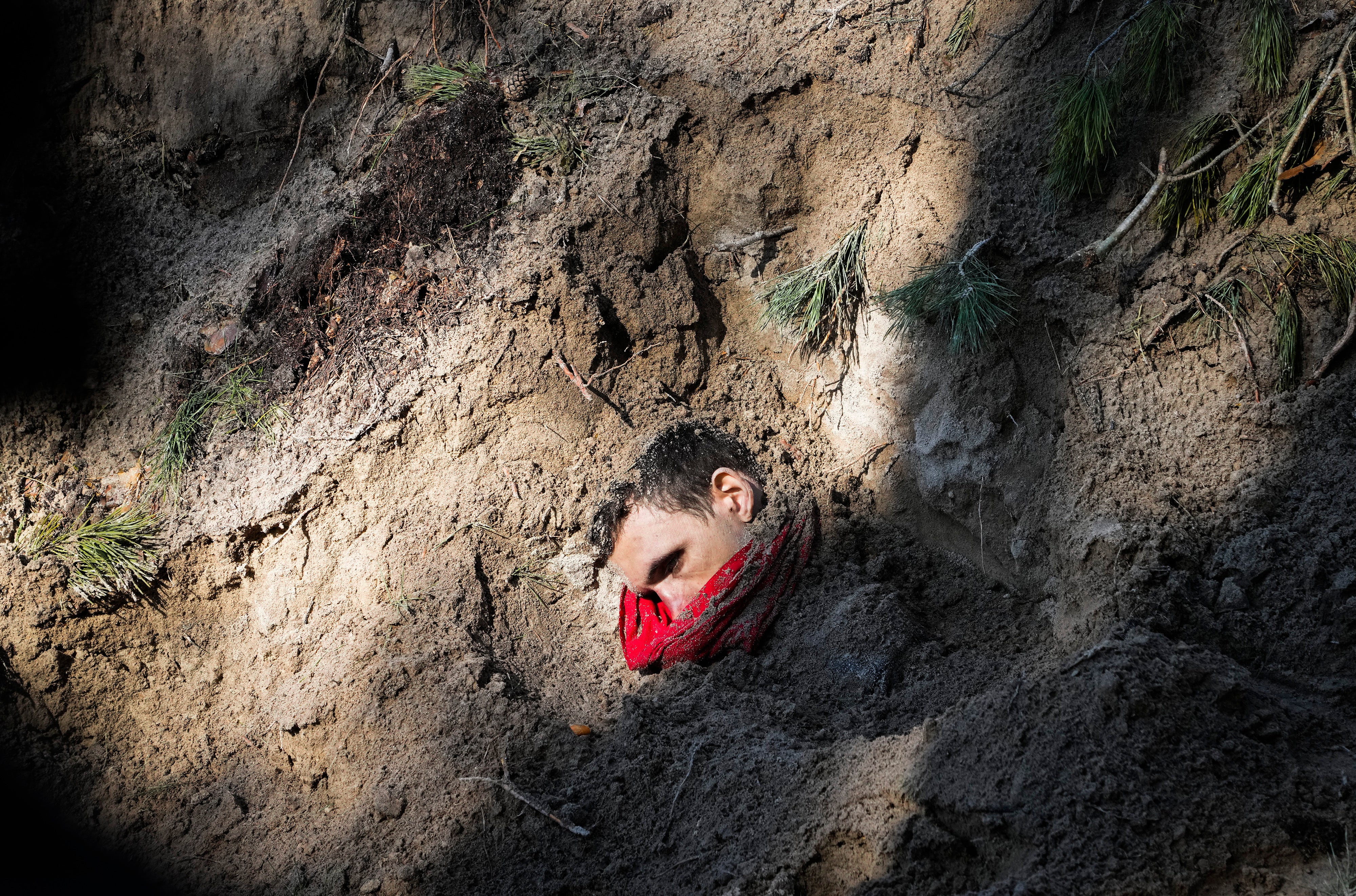 One of four bodies, including the village mayor and her family, is exposed in a mass grave in Motyzhyn, close to Kyiv