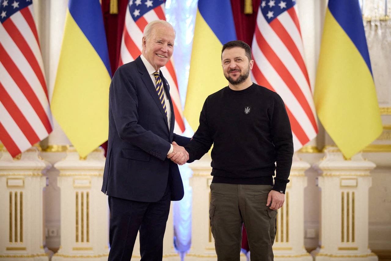 Ukraine’s President Volodymyr Zelenskiy and US President Joe Biden shake hands before a meeting