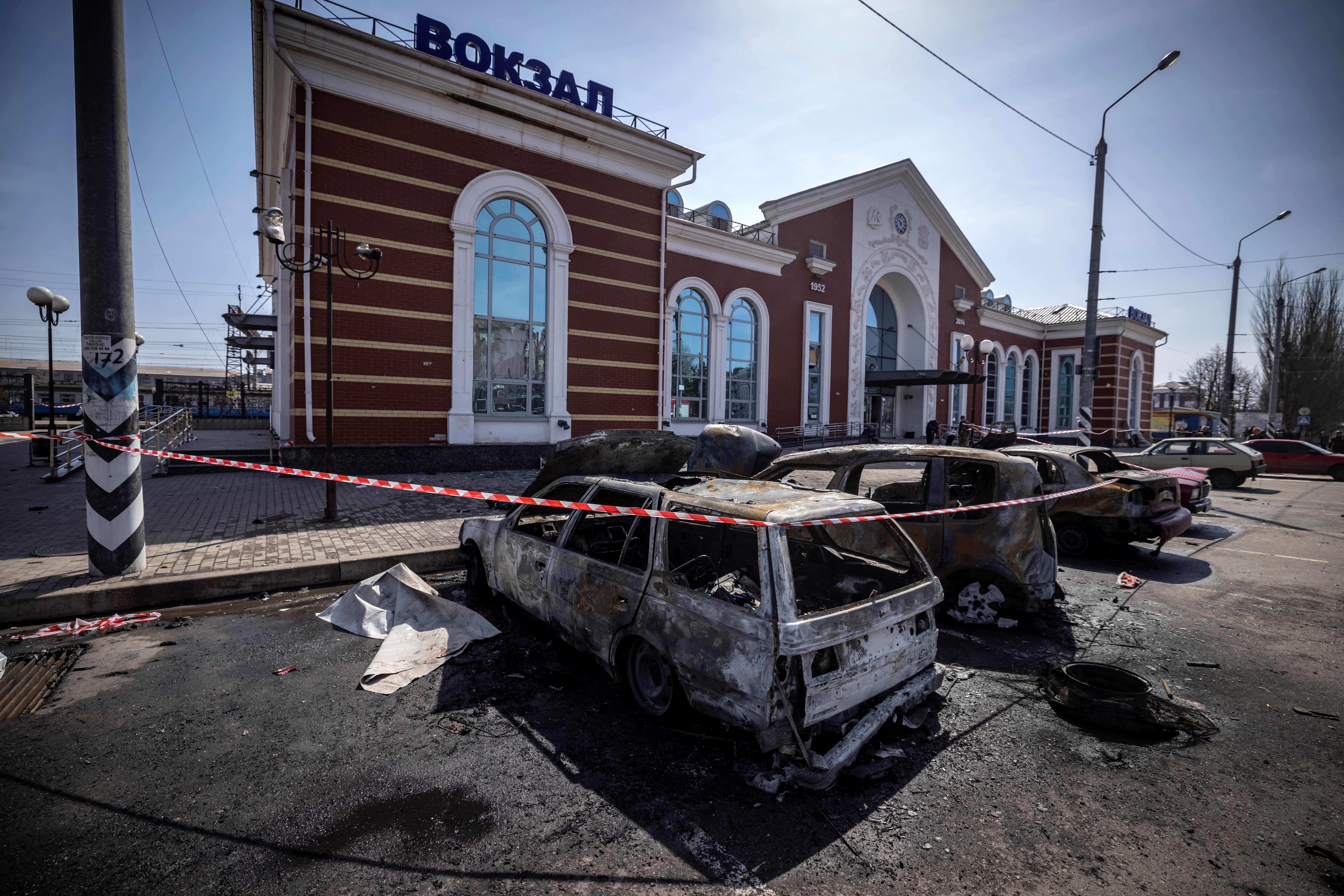 Calcinated cars are pictured outside a train station in Kramatorsk, eastern Ukraine, that was being used for civilian evacuations, after it was hit by a missile attack killing at least 58 people on 8 April last year