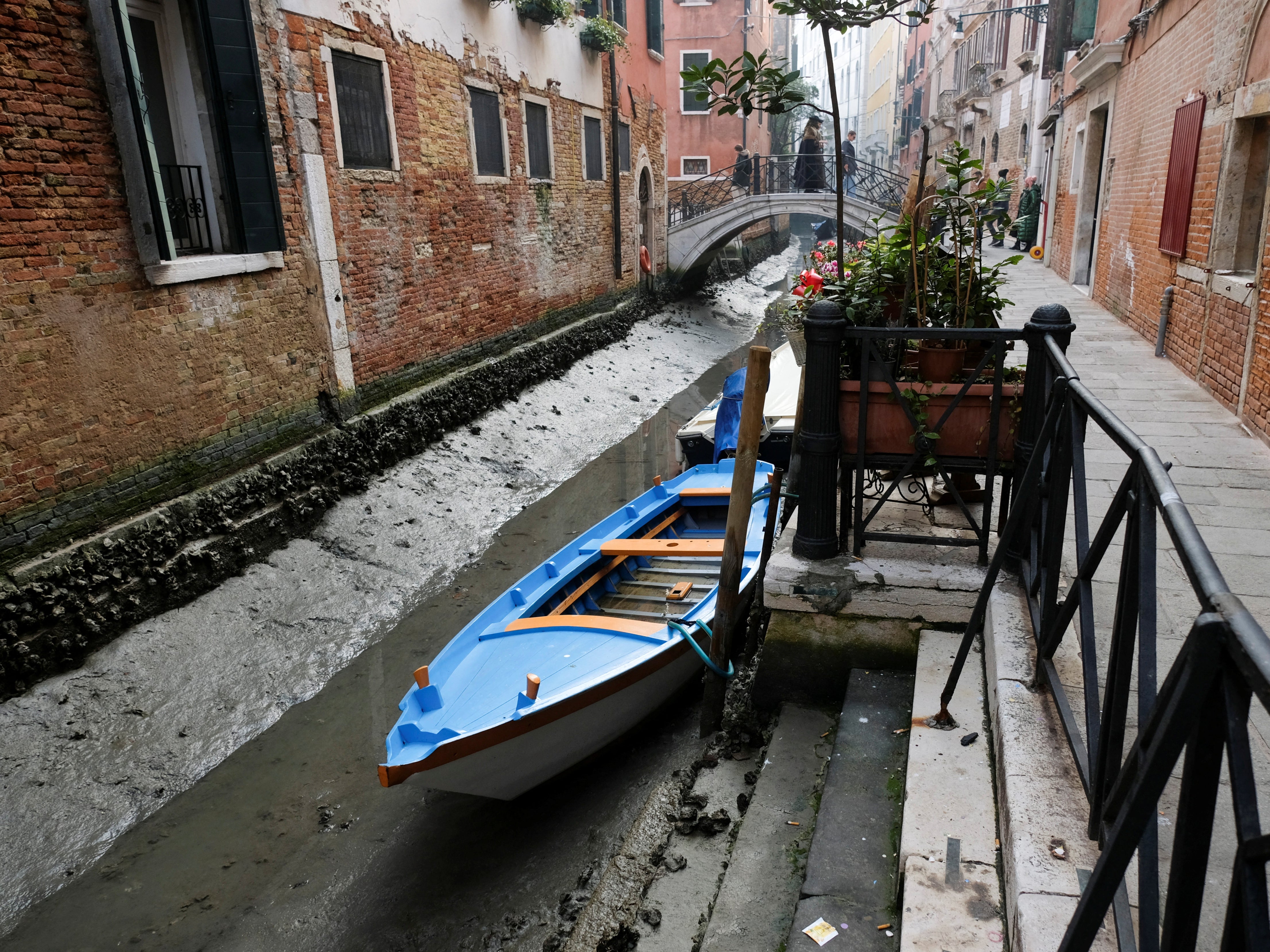 Boats caught during a severe low tide in Venice