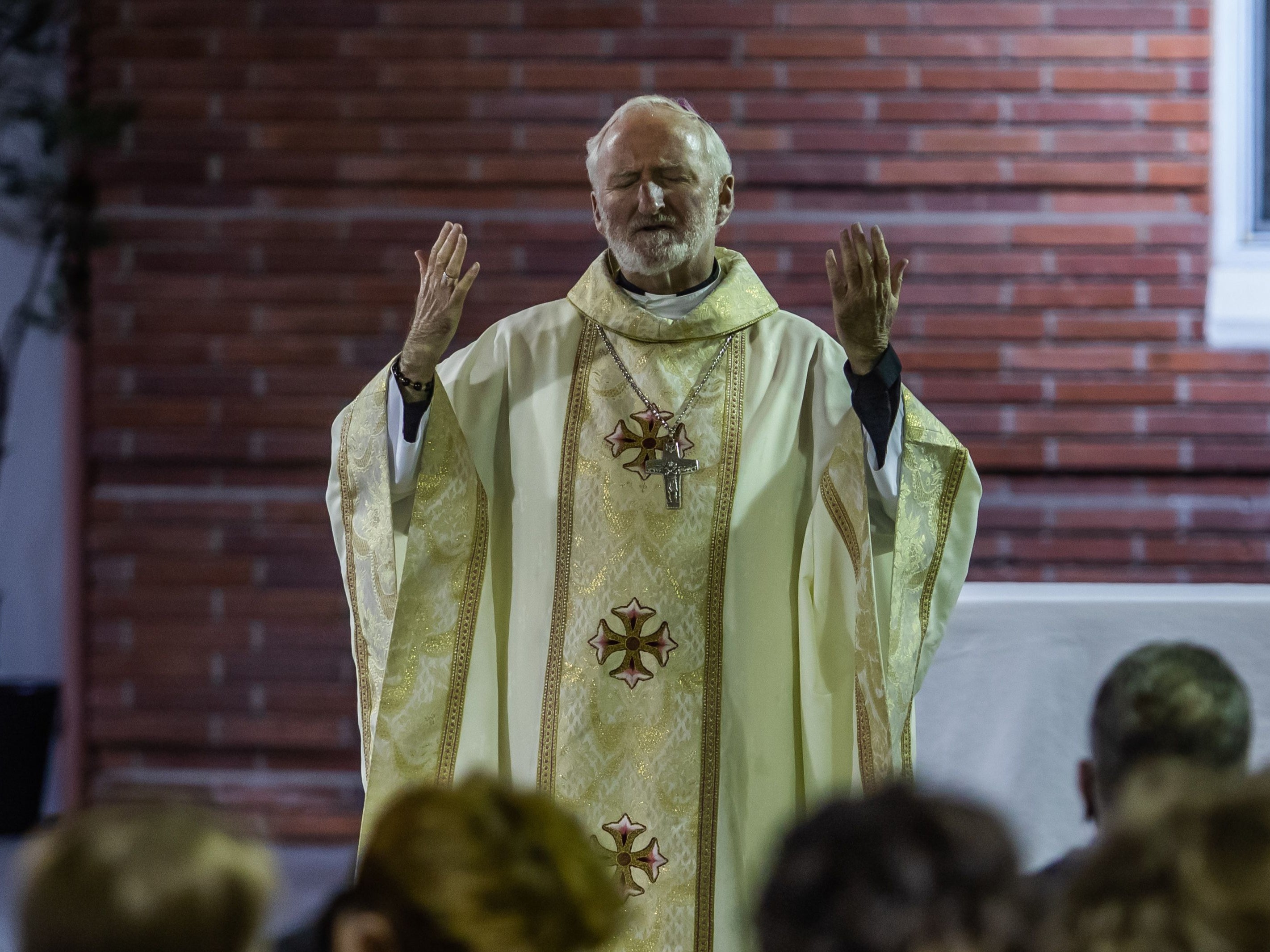 Bishop David O'Connell leads a non-denominational memorial service to provide a space for community members who have lost loved ones in 2020