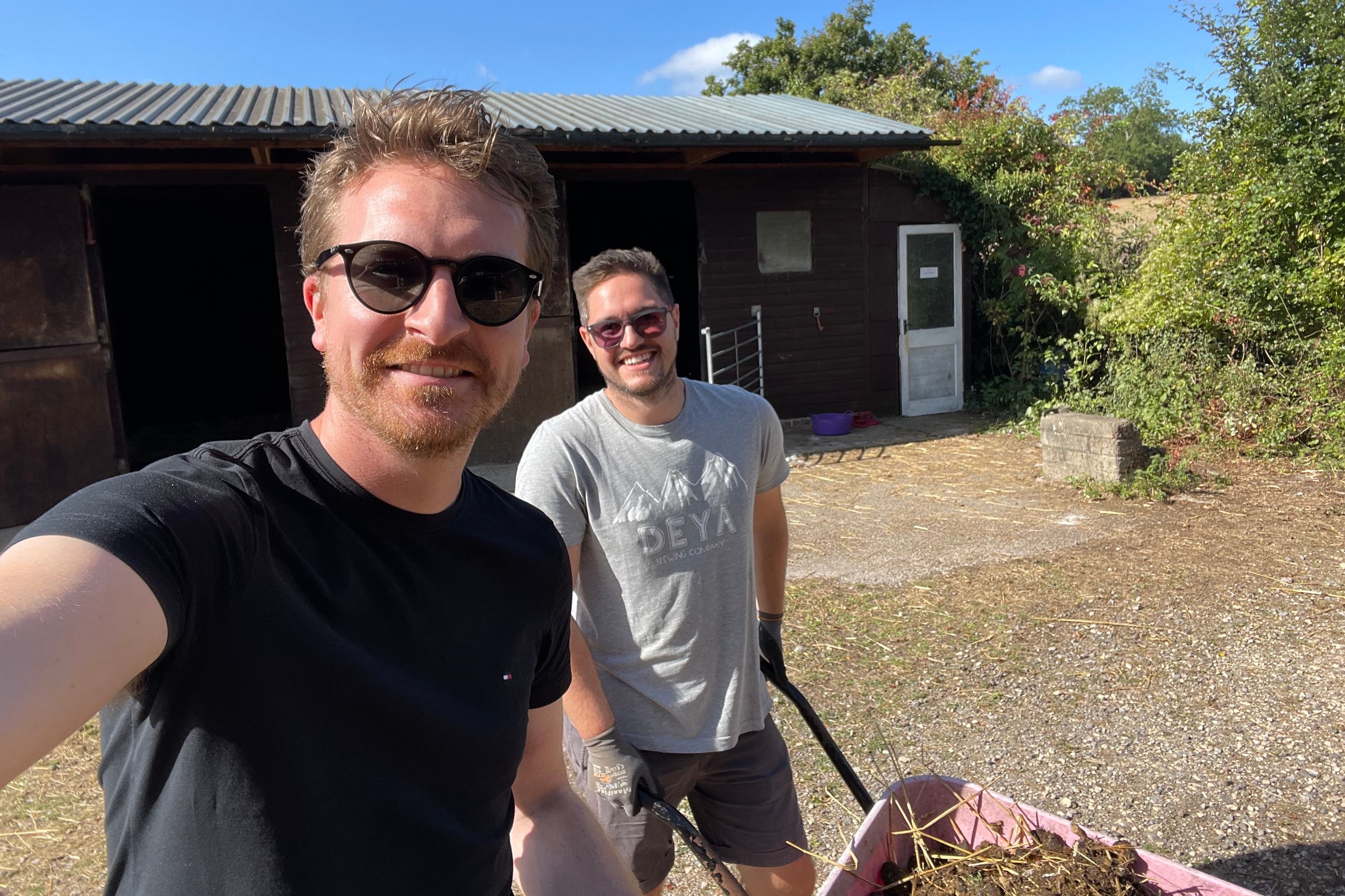 Tyler Grange director Jack Jewell (left) volunteering at a farm charity with a colleague on their Fridays off work (Jack Jewell/PA)