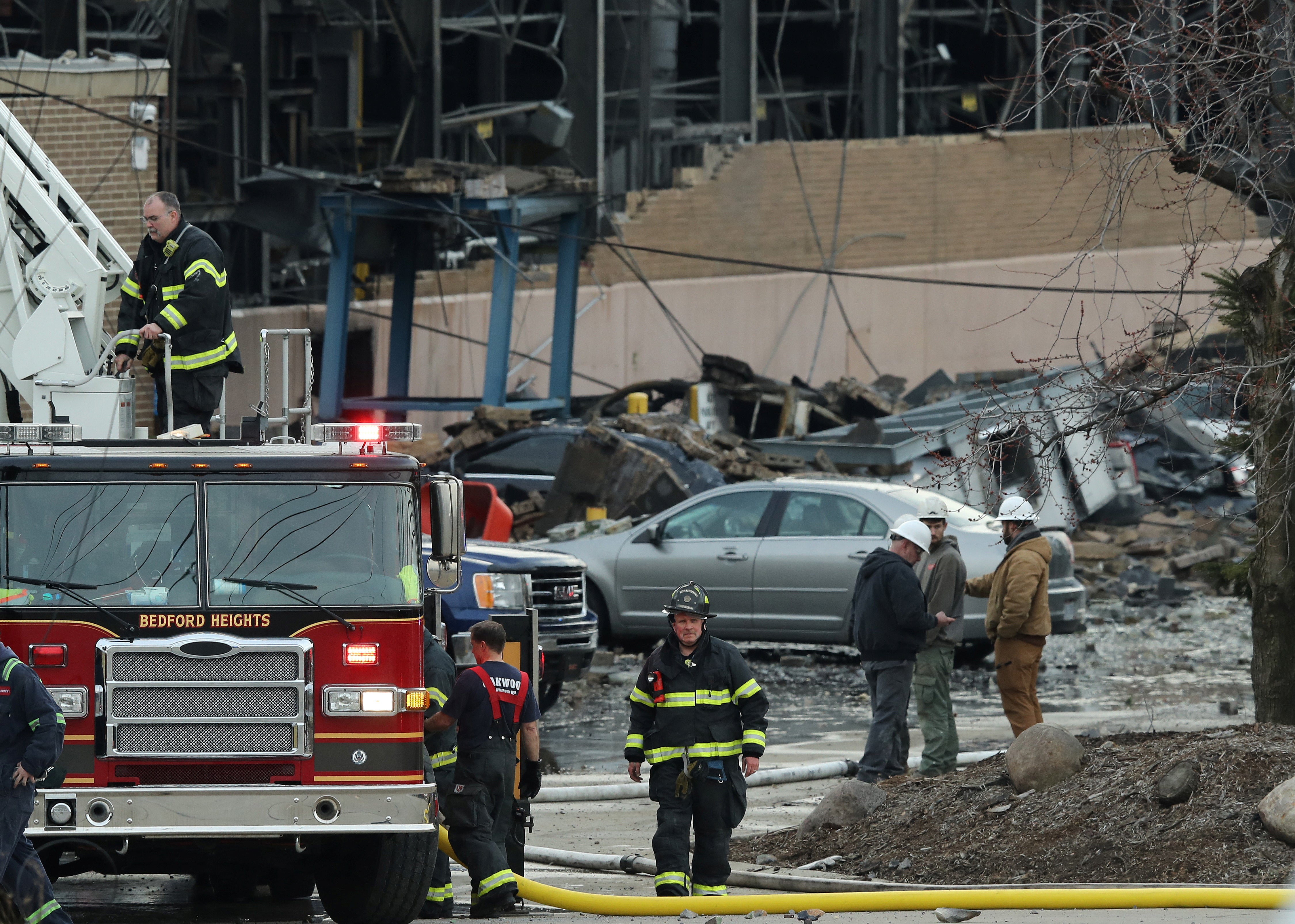 Firefighters begin to pack up gear at the I. Schumann & Co. metals plant after an explosion at the factory in Bedford, Ohio