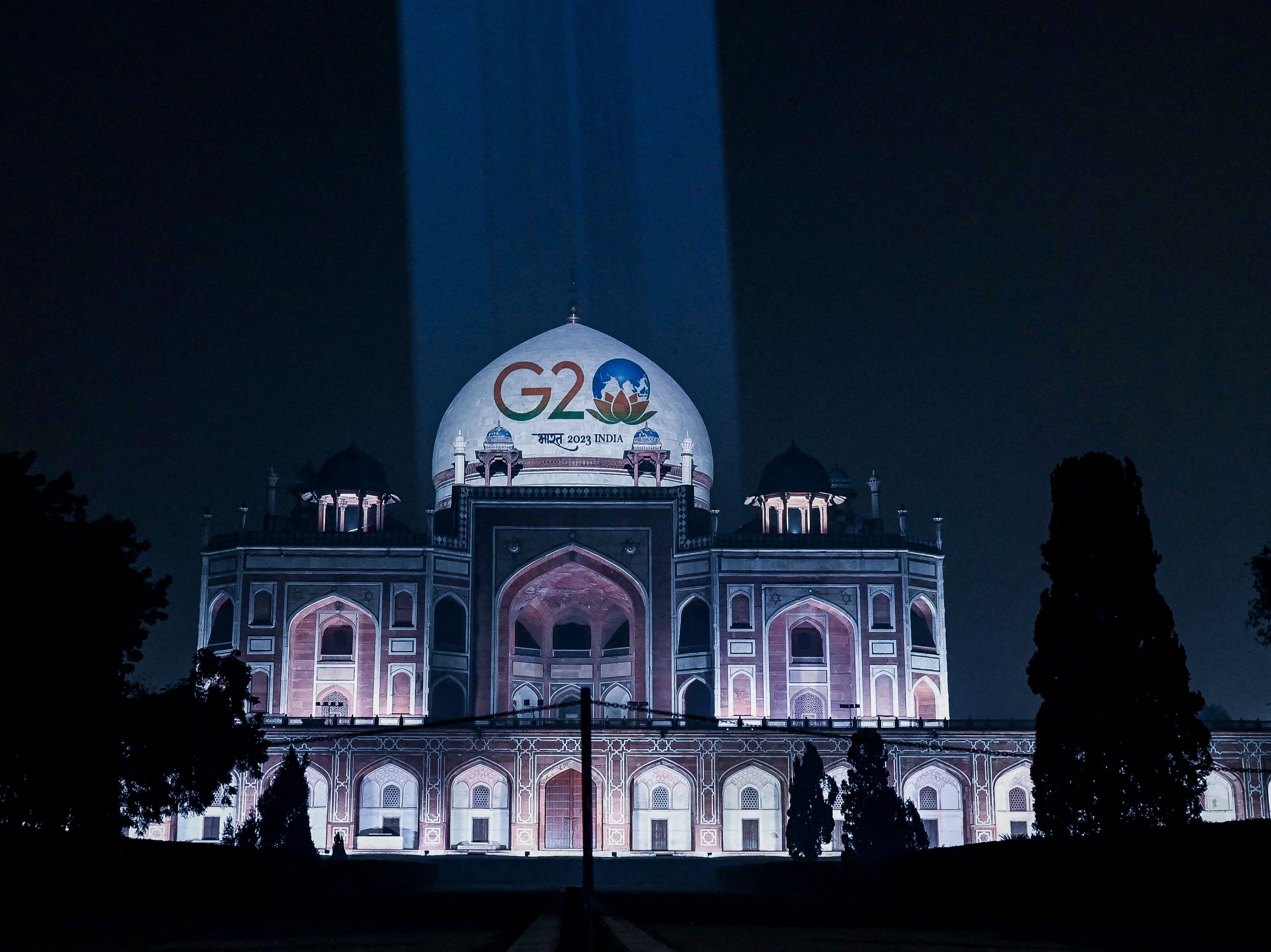 India's G20 logo is projected on the dome of illuminated Humayuns tomb in Delhi