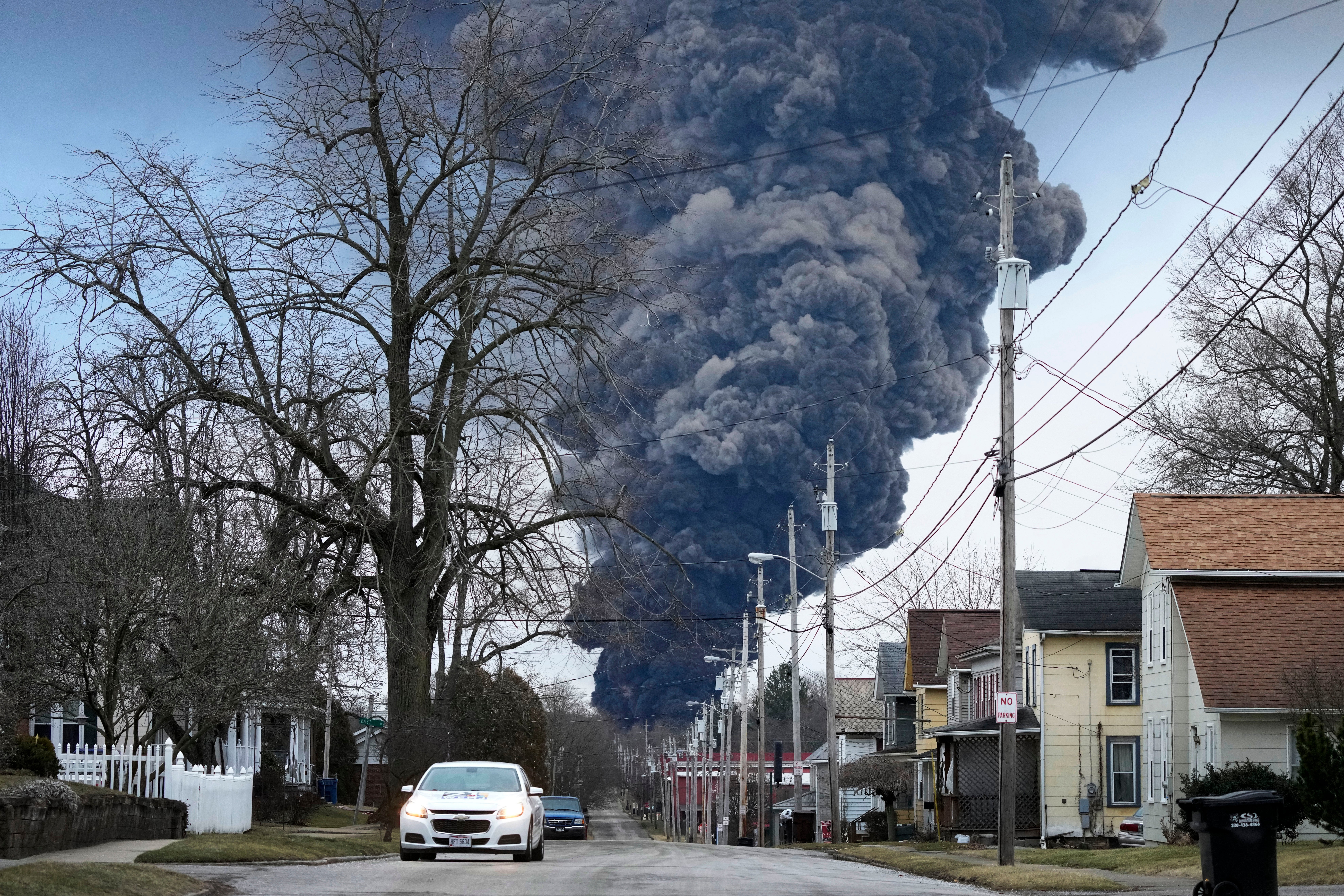 A black plume rises over East Palestine, Ohio, after the controlled detonation of a portion of the derailed Norfolk Southern train