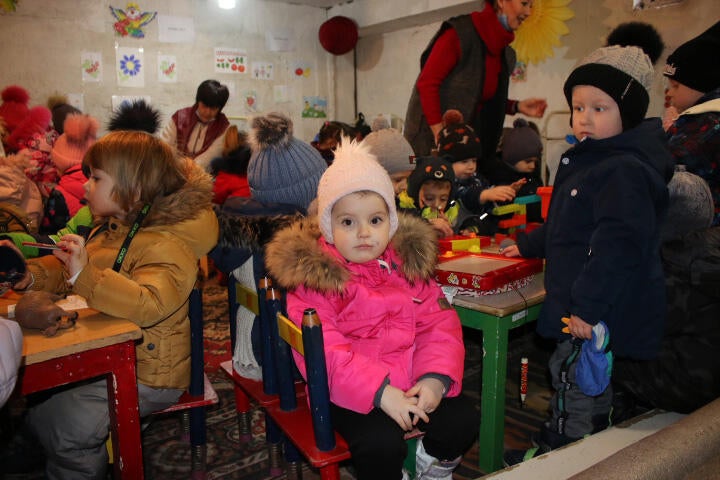 Kindergarten children take shelter during an air raid alert in Dnipro region