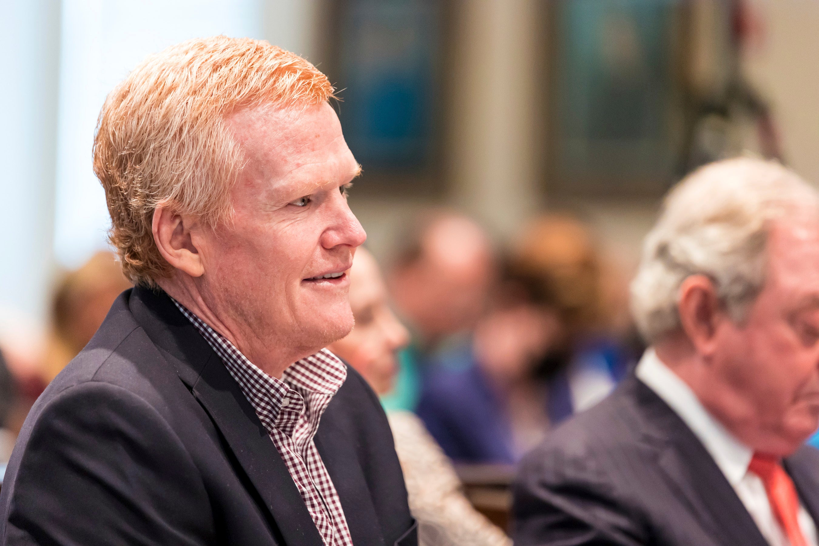 Alex Murdaugh smiles while listening to his son Buster Murdaugh testify during his trial