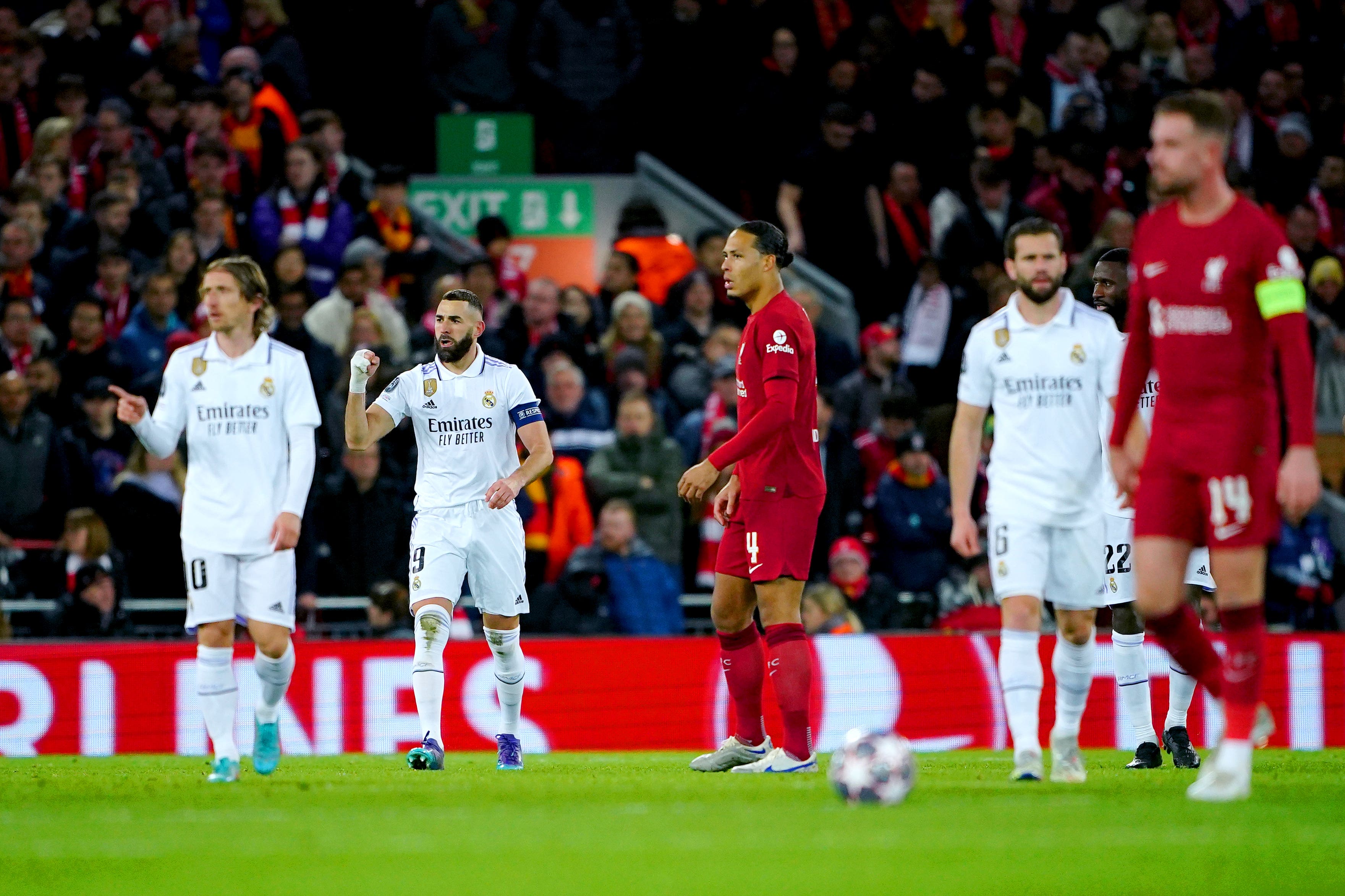 Liverpool’s Virgil van Dijk and Jordan Henderson react as Karim Benzema, second left, celebrates scoring Real Madrid’s fourth goal