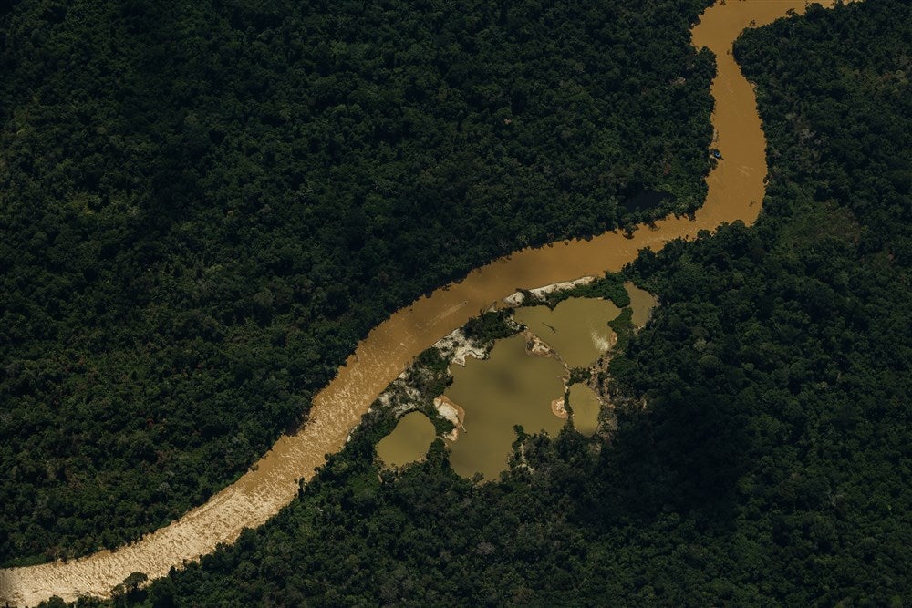 The waters of Mucajai river are dark due to the presence of illegal mining