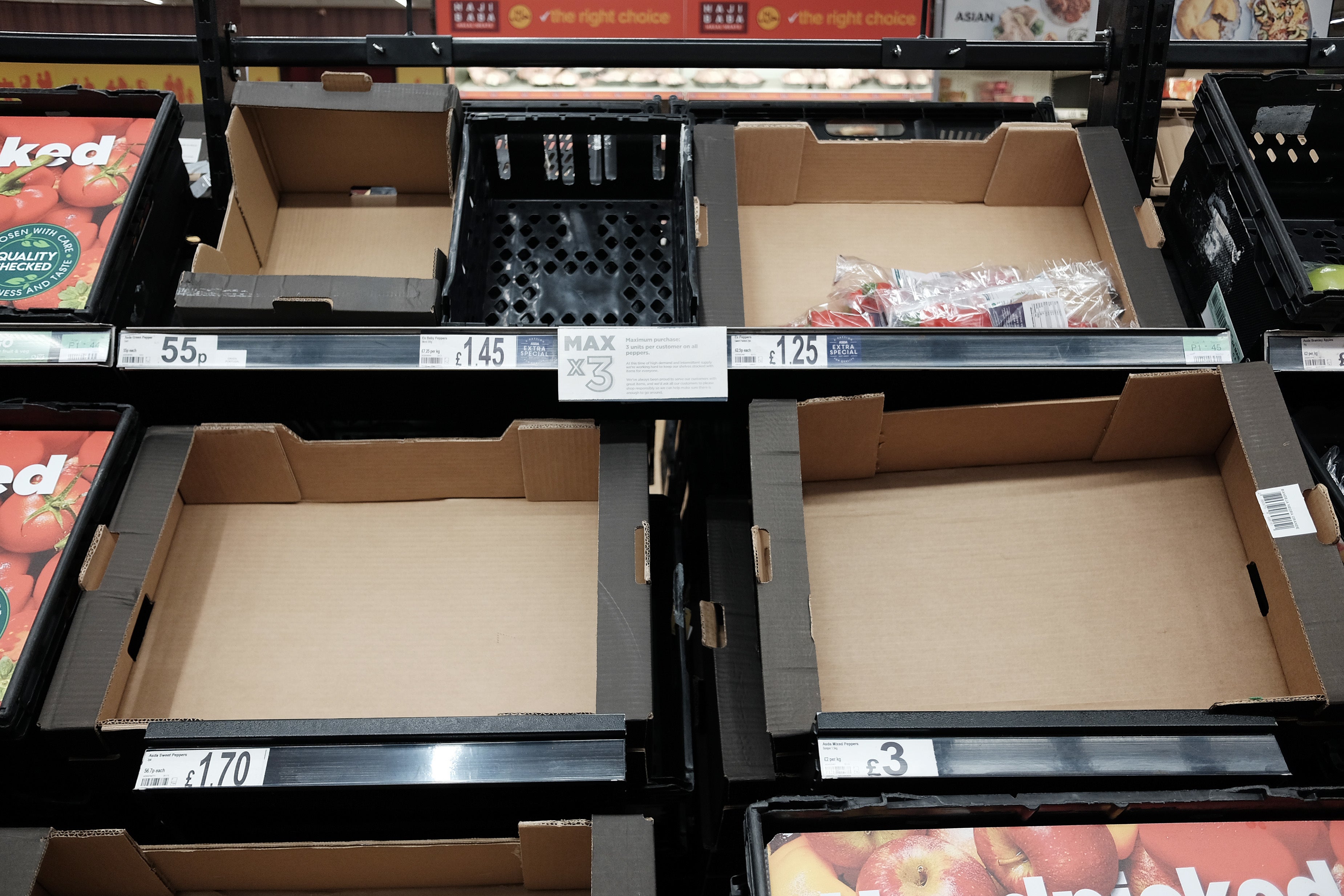 Empty fruit and vegetable shelves at an Asda in east London