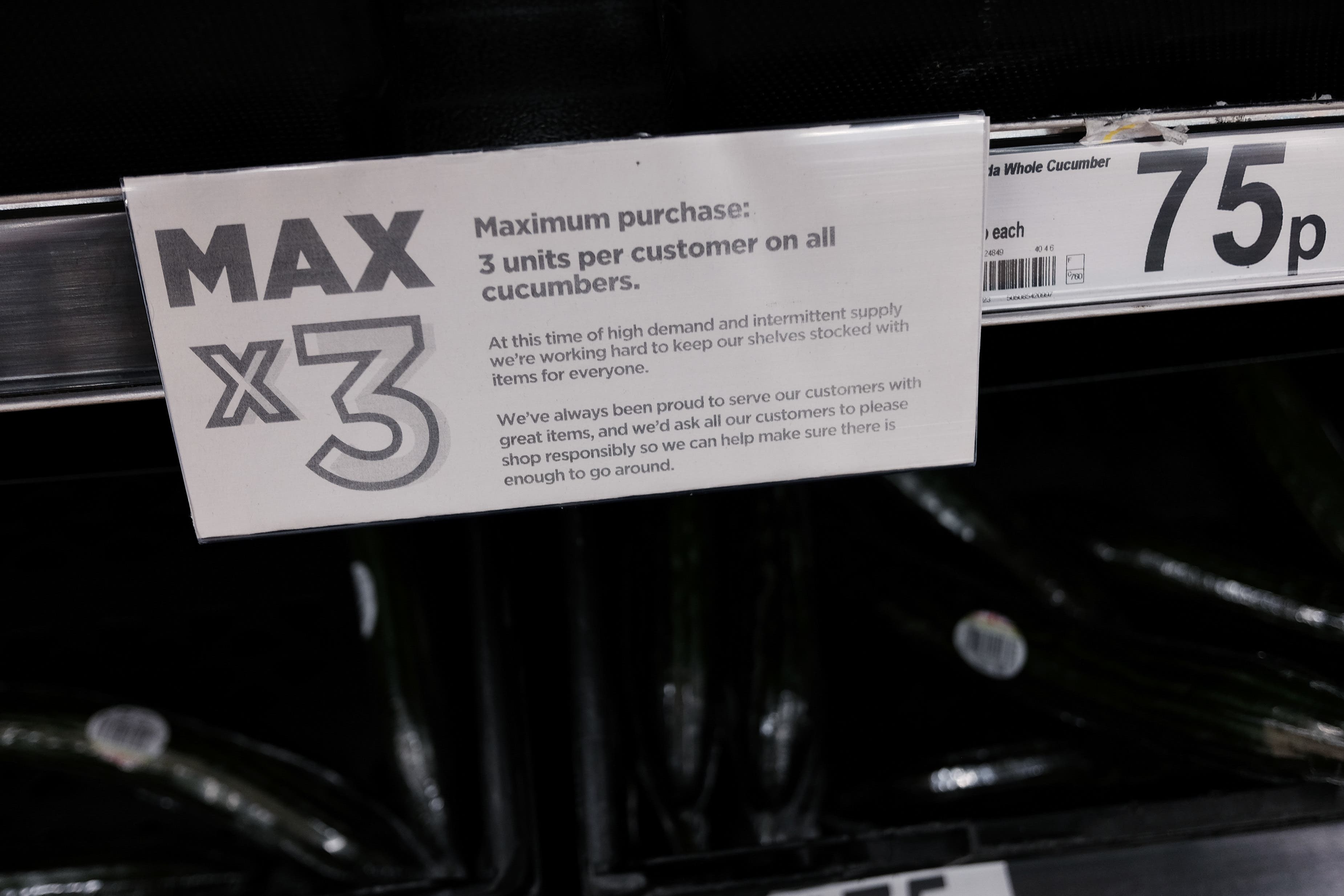 Empty fruit and vegetable shelves at an Asda in east London with a Max 3 units sign (Yui Mok/PA)