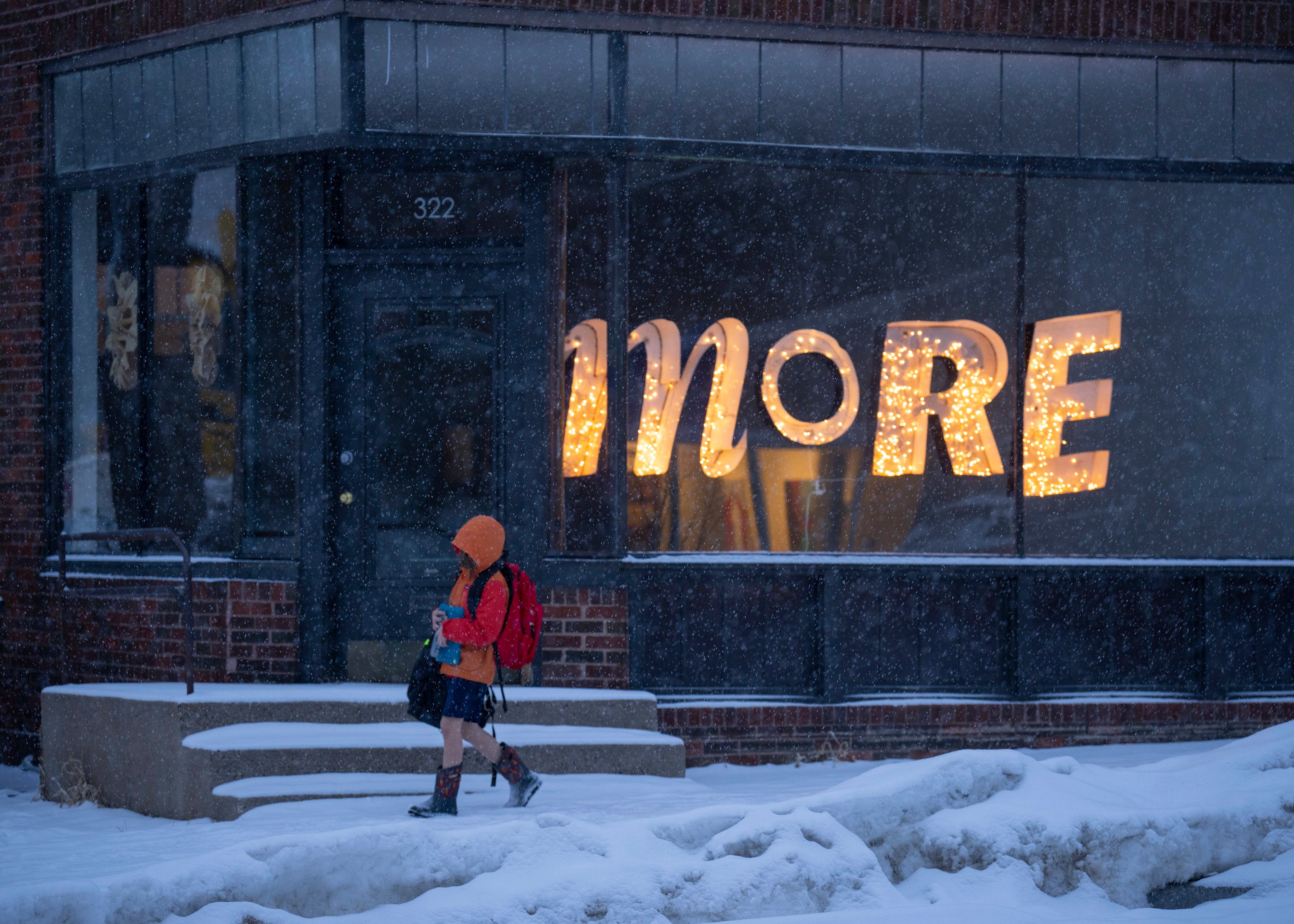 A youngster walks home from school in Minneapolis as snow falls from a winter storm hitting the Twin Cities on Tuesday (Jeff Wheeler/Star Tribune via AP)